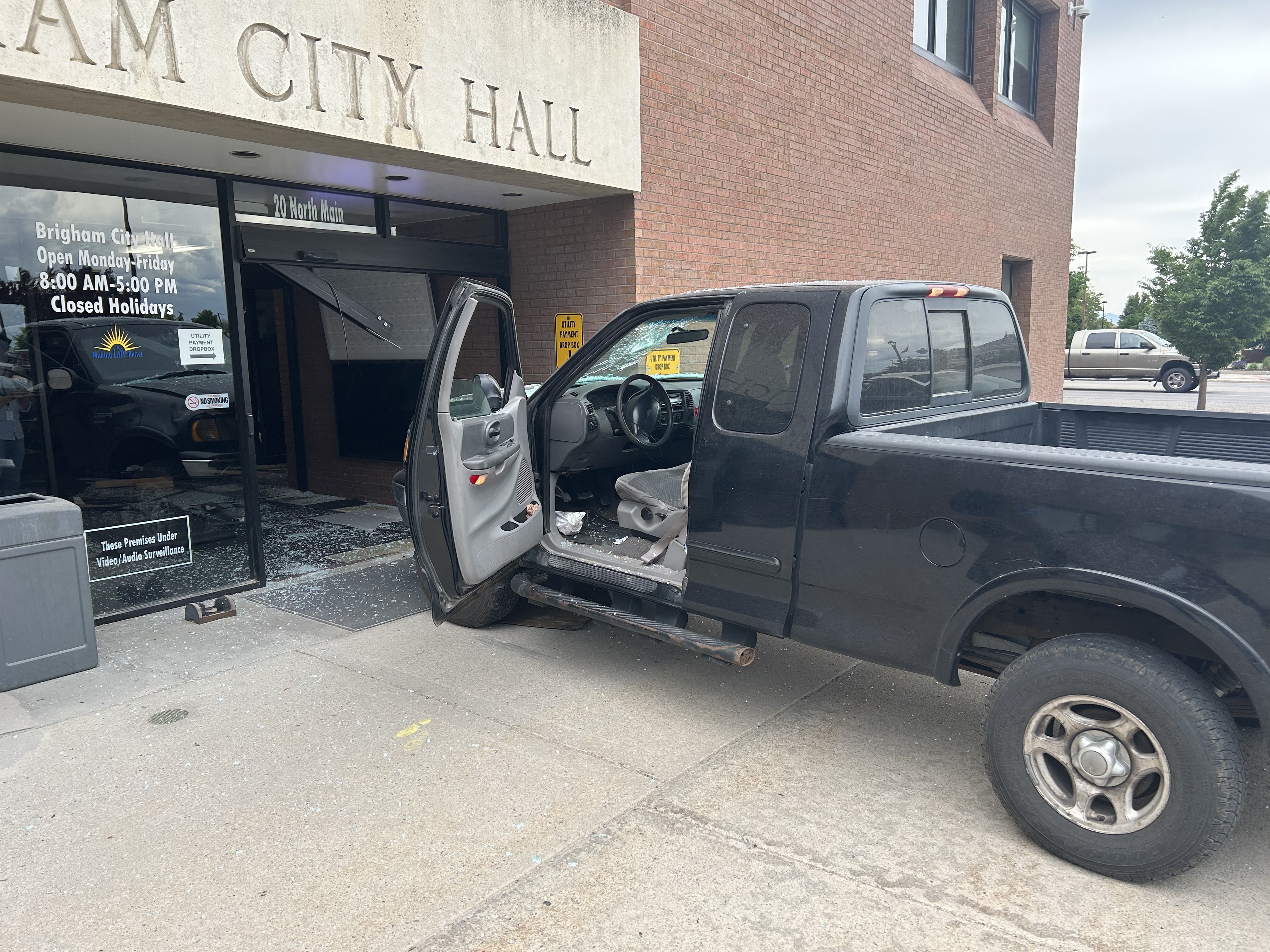 A man is being detained after police say he drove through the front doors of Brigham City Hall on Thursday, crashing into the lobby.