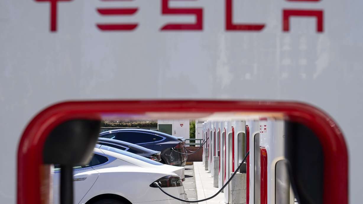 Tesla vehicles charge at a station in Emeryville, Calif., Aug. 10, 2022. Electric vehicles made by General Motors will be able to use much of Tesla's vast charging network starting early next year.