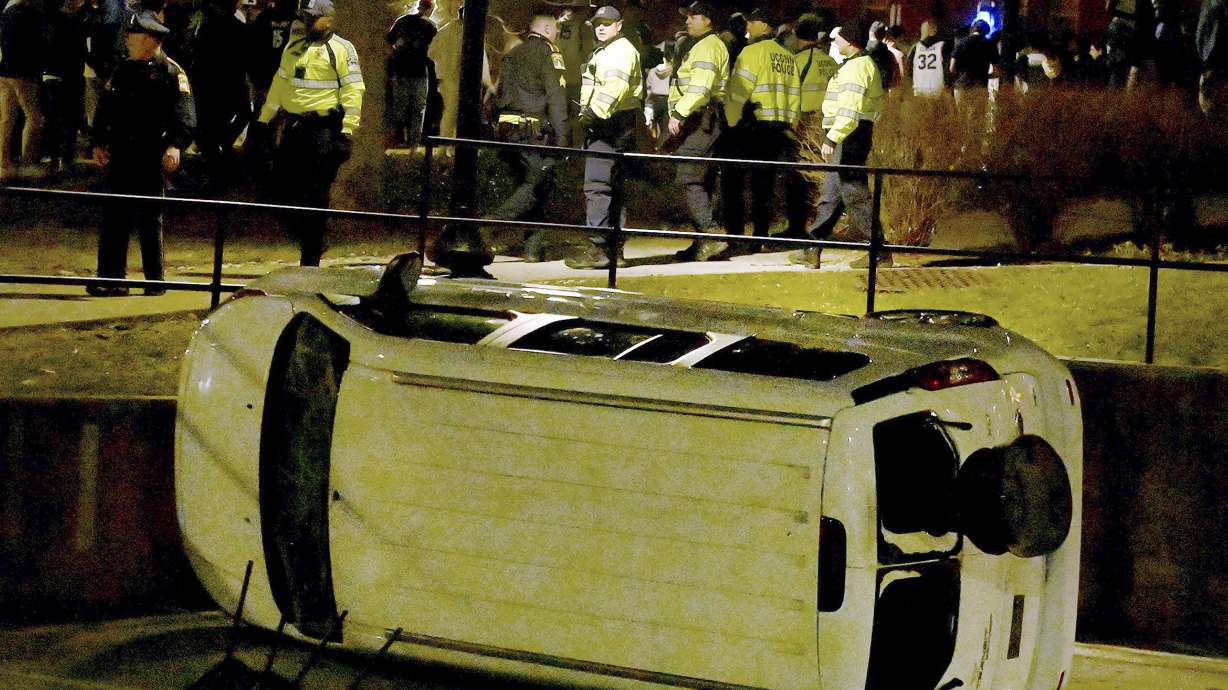 FILE - A vehicle is overturned as UConn Police and Connecticut State Police try to maintain order early April 4, 2023, in Storrs, Conn., following UConn's NCAA championship basketball game. Some UConn students are getting expelled for vandalizing their campus, a university spokesperson said Friday, June 9, 2023.
