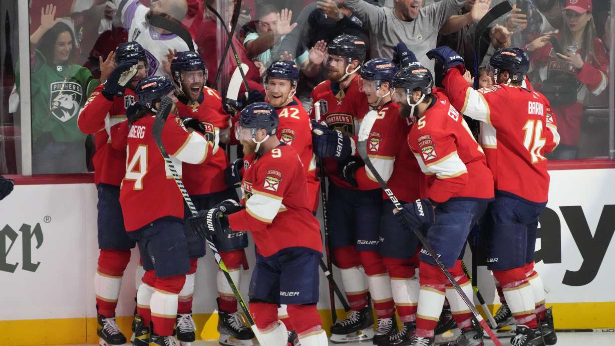 The Florida Panthers team celebrate after center Carter Verhaeghe (23), third from left, scored the game winning goal during overtime in Game 3 of the NHL hockey Stanley Cup Finals, Thursday, June 8, 2023, in Sunrise, Fla. The Florida Panthers defeated the Vegas Golden Knights 3-2.
