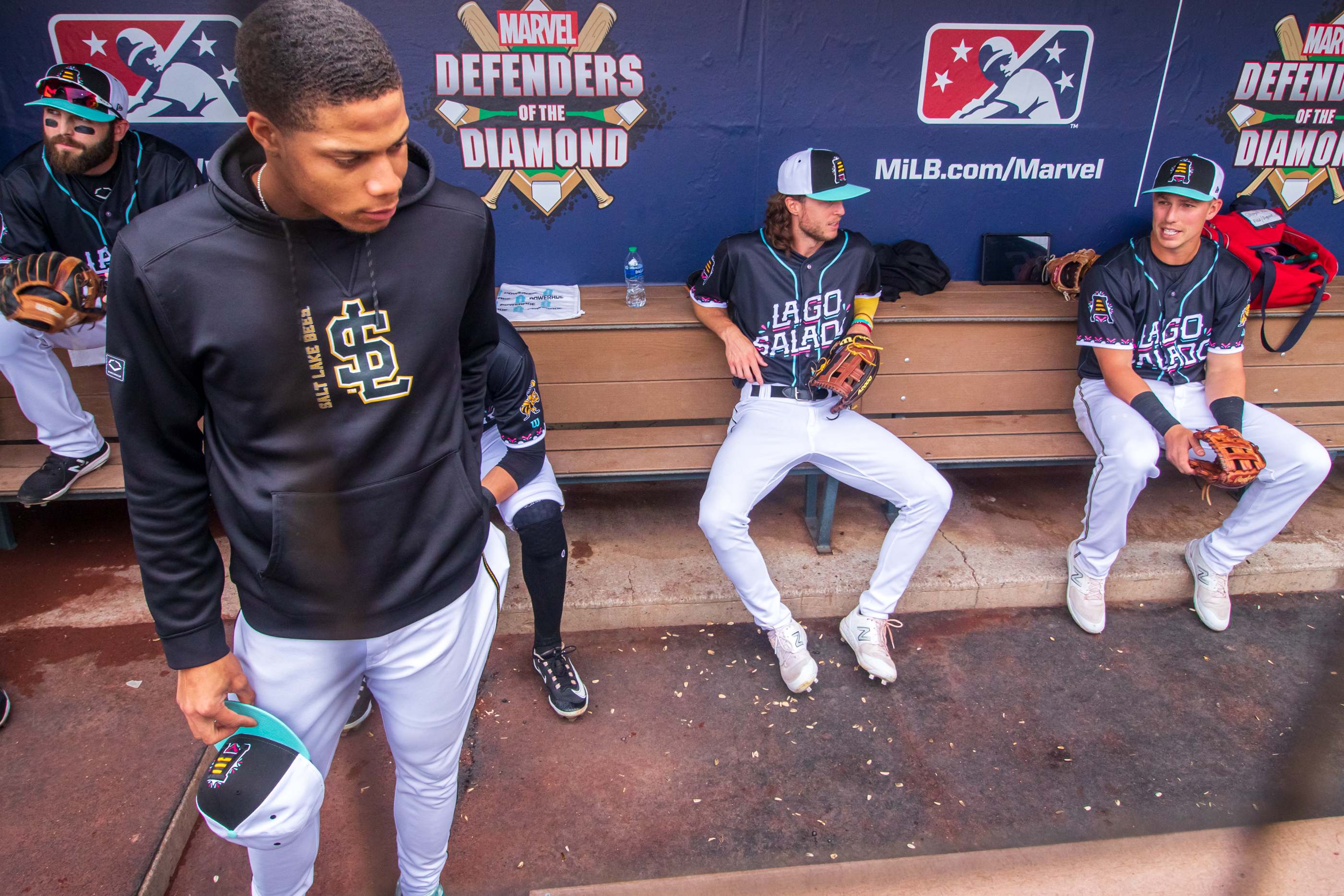 Salt Lake Bees outfielder Brett Phillips, second from right, chats with teammates before a game at Smith's Ballpark on Thursday.