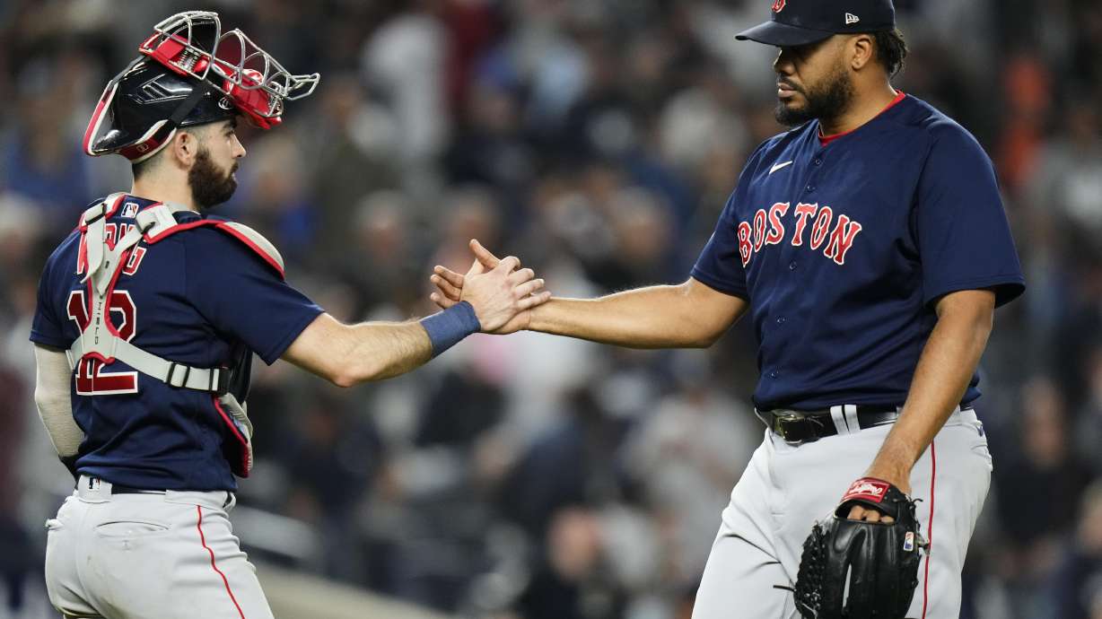 Boston Red Sox relief pitcher Kenley Jansen, right, celebrates with catcher Connor Wong (12) after the team's 3-2 win in a baseball game against the New York Yankees on Friday, June 9, 2023, in New York.