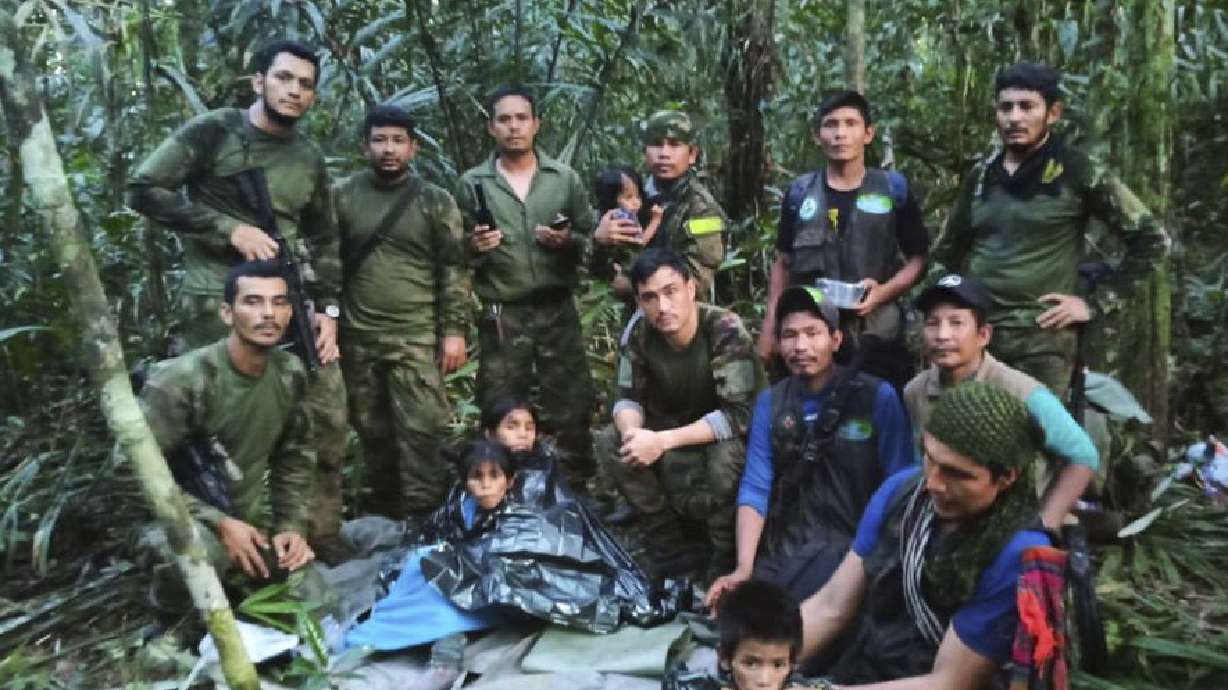 Soldiers and Indigenous men pose for a photo with the four Indigenous brothers who were missing after a deadly plane crash, in the Solano jungle, Caqueta state, Colombia, Friday.