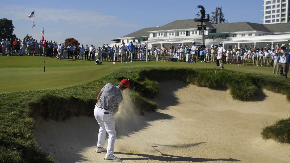 FILE - Cameron Champ, of the United States, hits out of a bunker on the ninth hole during the Walker Cup golf matches at Los Angeles Country Club on Sept. 10, 2017, in Los Angeles. The Los Angeles Country Club is opening itself to the world's largest golf audiences with the arrival of the 123rd U.S. Open next week. For its first century of existence, the club and its two courses were rarely seen by anyone except its wealthy members.