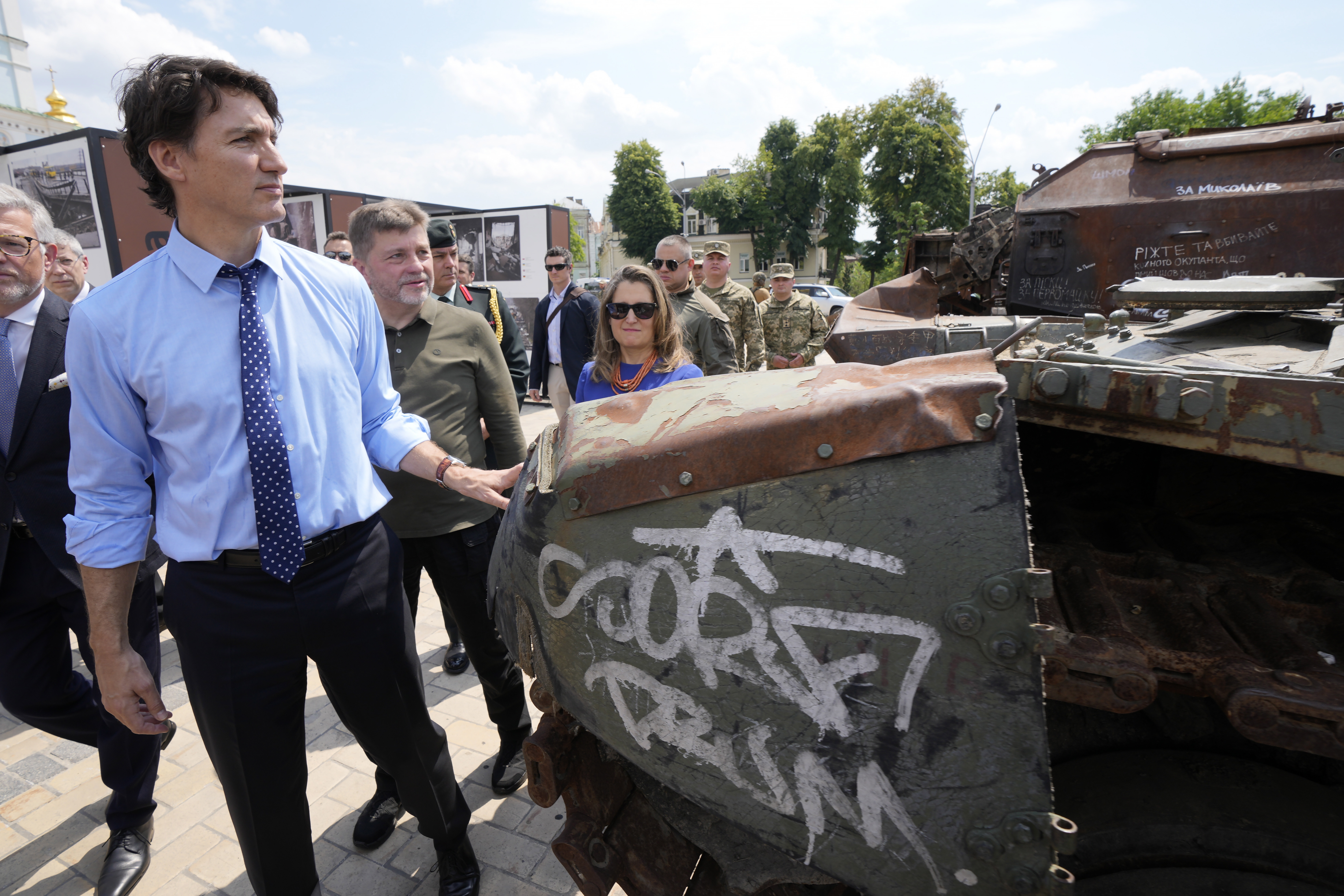 Canadian Prime Minister Justin Trudeau, left, accompanied by Deputy Prime Minister and Minister of Finance Chrystia Freeland, walks past burned out Russian tanks in Kyiv, Ukraine, Saturday.