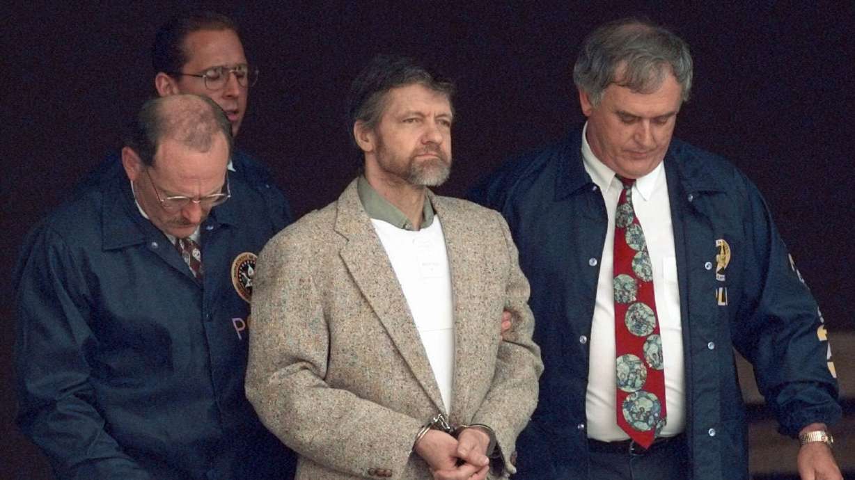 Theodore Kaczynski looks around as U.S. Marshals prepare to take him down the steps at the federal courthouse to a waiting vehicle on June 21, 1996, in Helena, Mont. Kaczynski, known as the “Unabomber,” has died in federal prison.