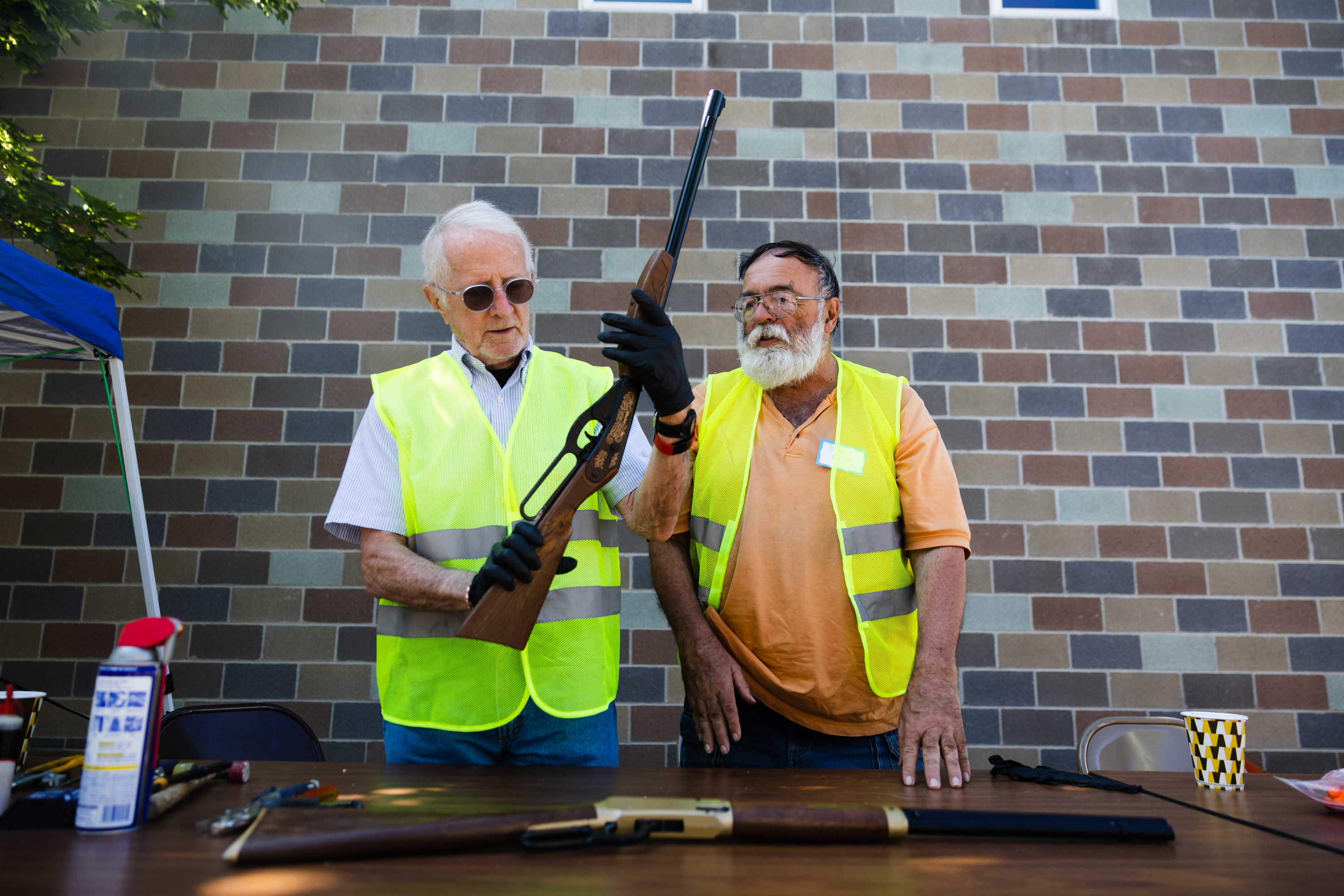 Bruce Travis, left, and another volunteer prepare to dismantle guns during an event disarming firearms at the Christ United Methodist Church in Salt Lake City on Saturday.