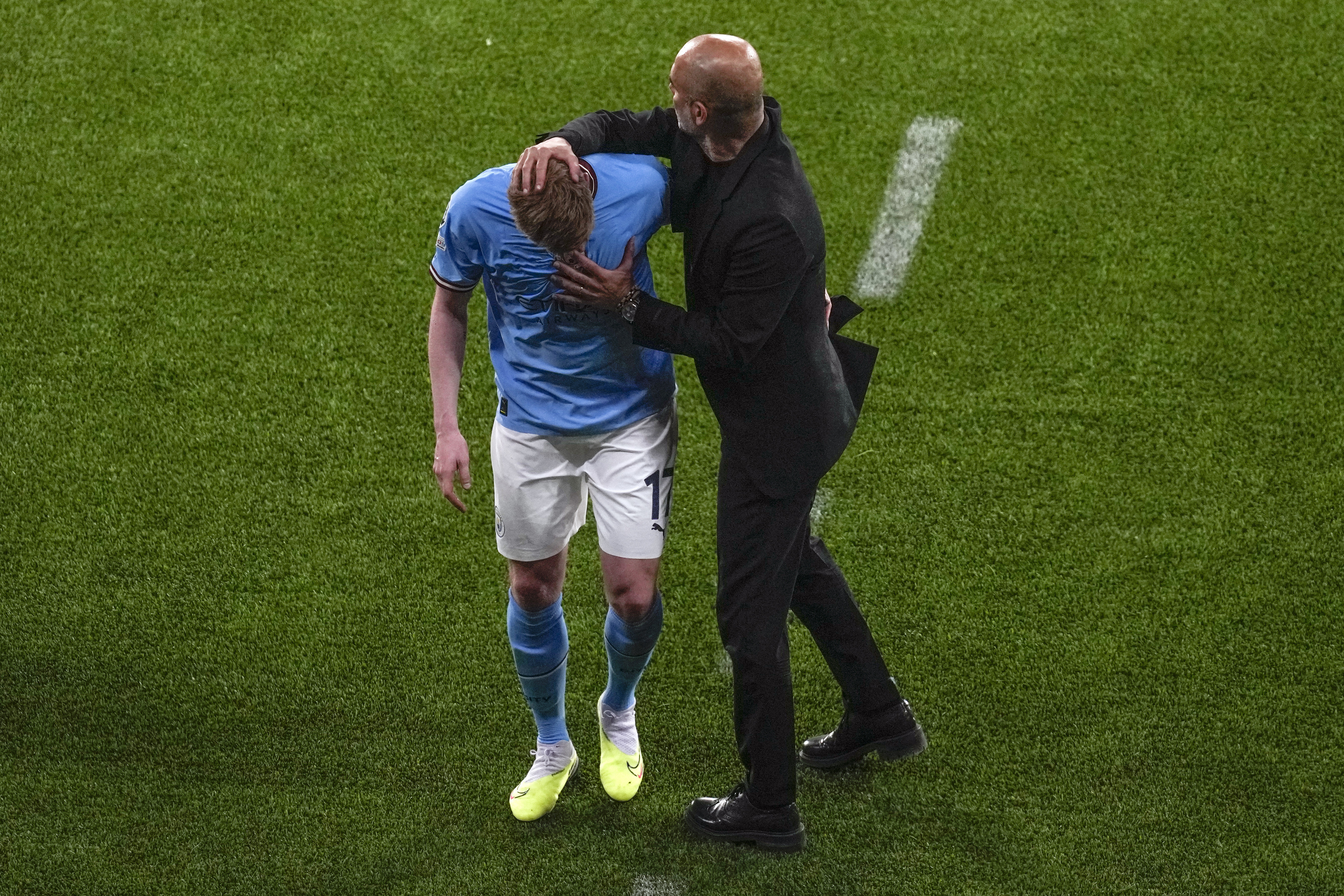Manchester City's head coach Pep Guardiola greets Kevin De Bruyne as he walks off the pitch to be replaced during the Champions League final soccer match between Manchester City and Inter Milan at the Ataturk Olympic Stadium in Istanbul, Turkey, Saturday, June 10, 2023.
