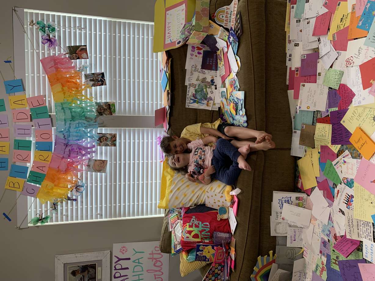 Charlotte Bauer, 5, of Centerville, poses with her brother and a portion of the thousands of letters sent for her birthday from around the world.