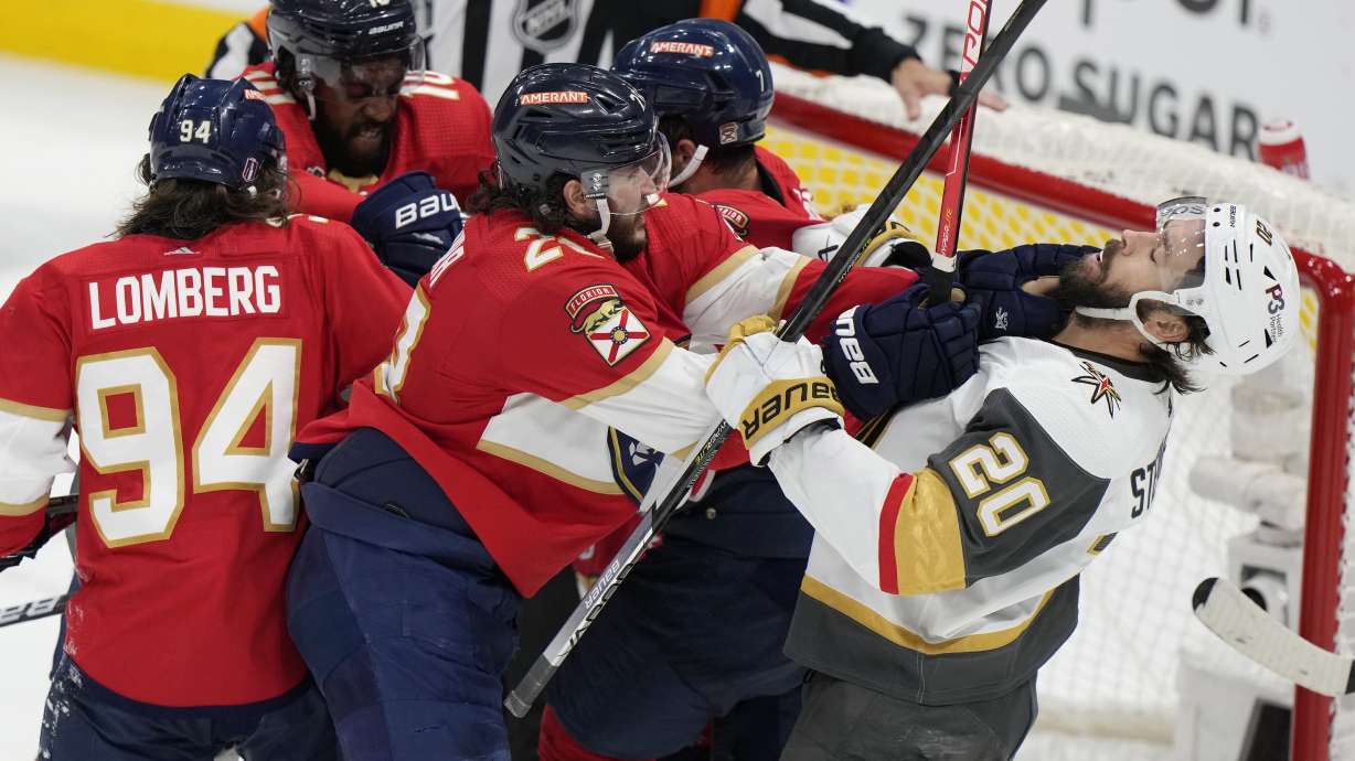 Florida Panthers defenseman Josh Mahura (28) and Vegas Golden Knights center Chandler Stephenson (20) fight during the third period in Game 4 of the NHL hockey Stanley Cup Finals, Saturday, June 10, 2023, in Sunrise, Fla.