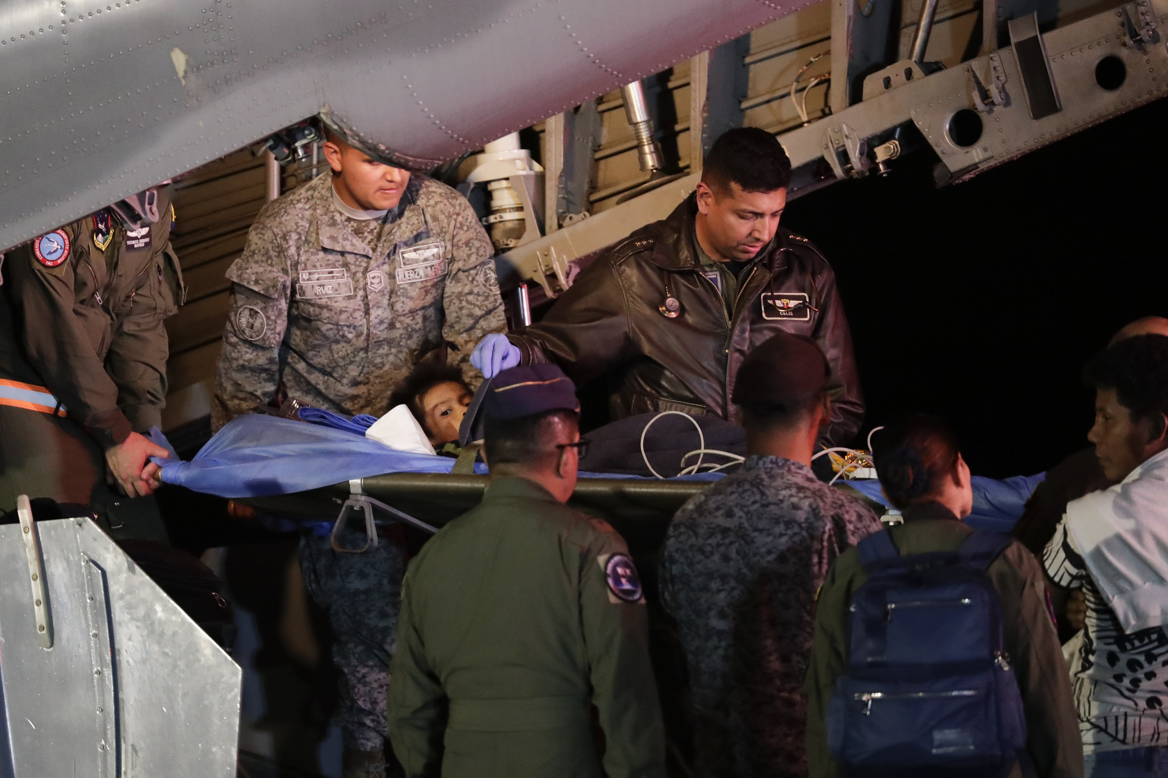 Military personnel unload from a plane one of four Indigenous children who were missing after a deadly plane crash at the military air base in Bogota, Colombia, Saturday. The children survived a small plane crash 40 days ago and had been the subject of an intense search in the jungle.