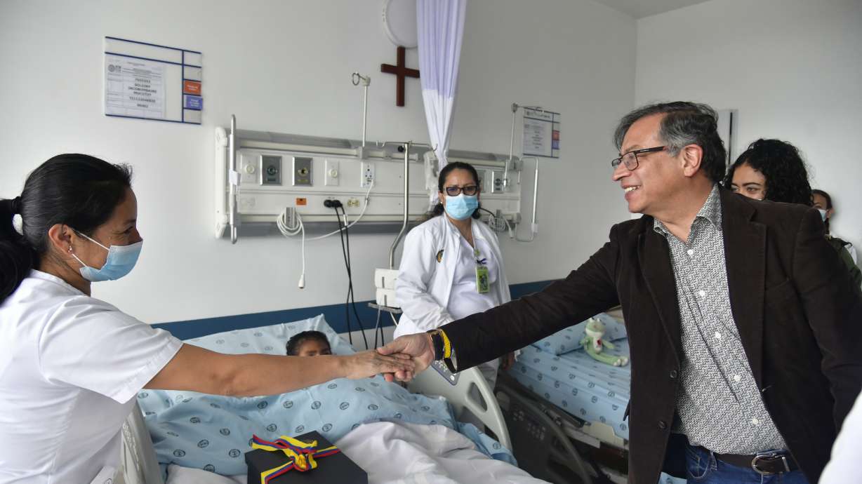 Colombia's President Gustavo Petro greets a nurse tending to one of the four Indigenous children who survived an Amazon plane crash that killed three adults and then braved the jungle for 40 days before being found alive, at a military hospital in Bogota, Colombia, Saturday.