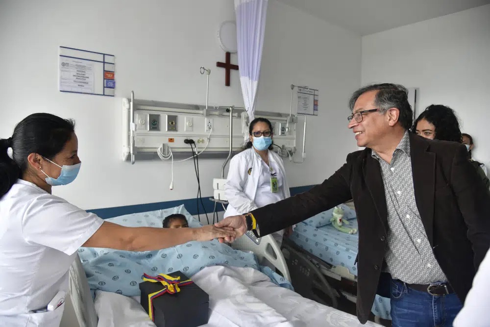 Colombia's President Gustavo Petro greets a nurse tending to one of the four Indigenous children who survived an Amazon plane crash that killed three adults and then braved the jungle for 40 days before being found alive, at a military hospital in Bogota, Colombia, Saturday.