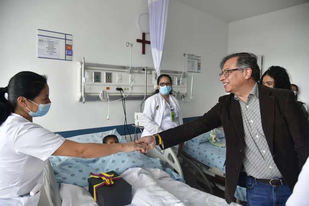Colombia's President Gustavo Petro greets a nurse tending to one of the four Indigenous children who survived an Amazon plane crash that killed three adults and then braved the jungle for 40 days before being found alive, at a military hospital in Bogota, Colombia, Saturday.