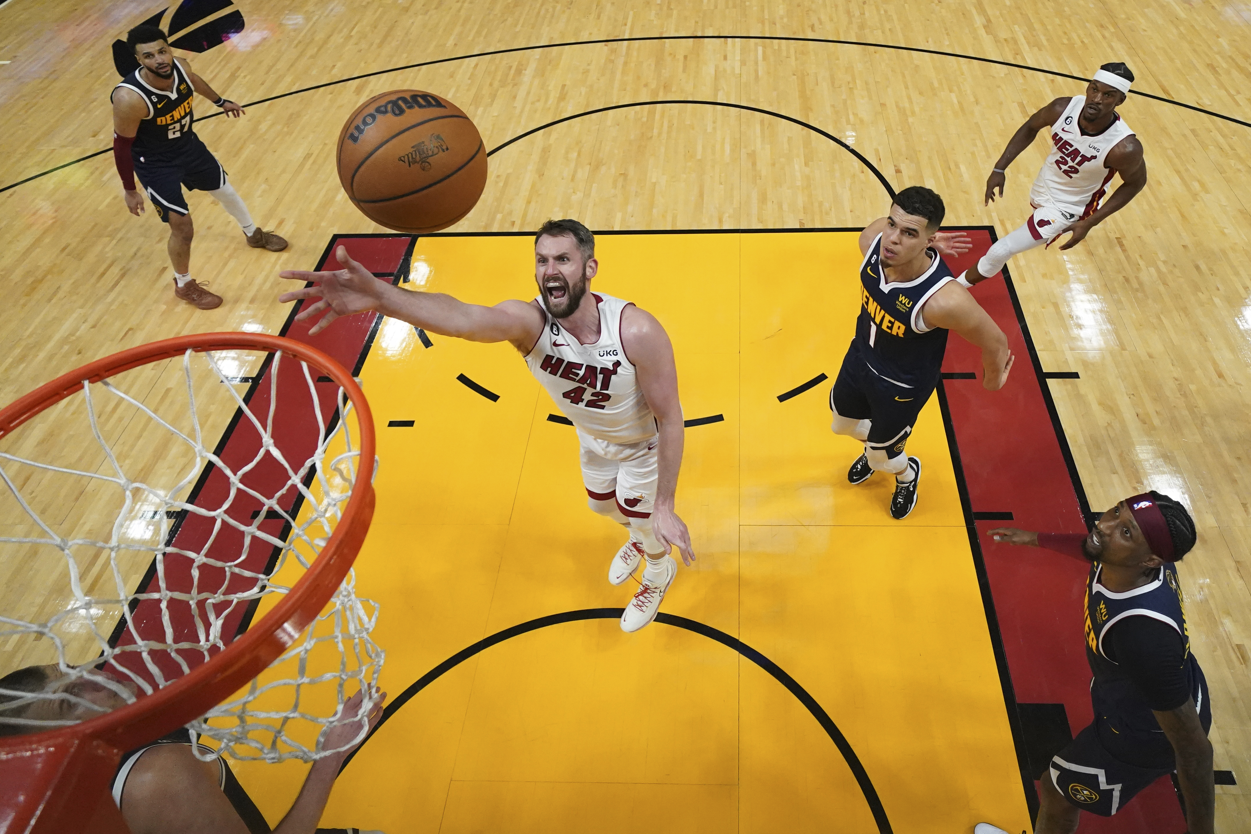 Miami Heat forward Kevin Love (42) shoots against the Denver Nuggets during the first half in Game 4 of the basketball NBA Finals, Friday, June 9, 2023, in Miami.