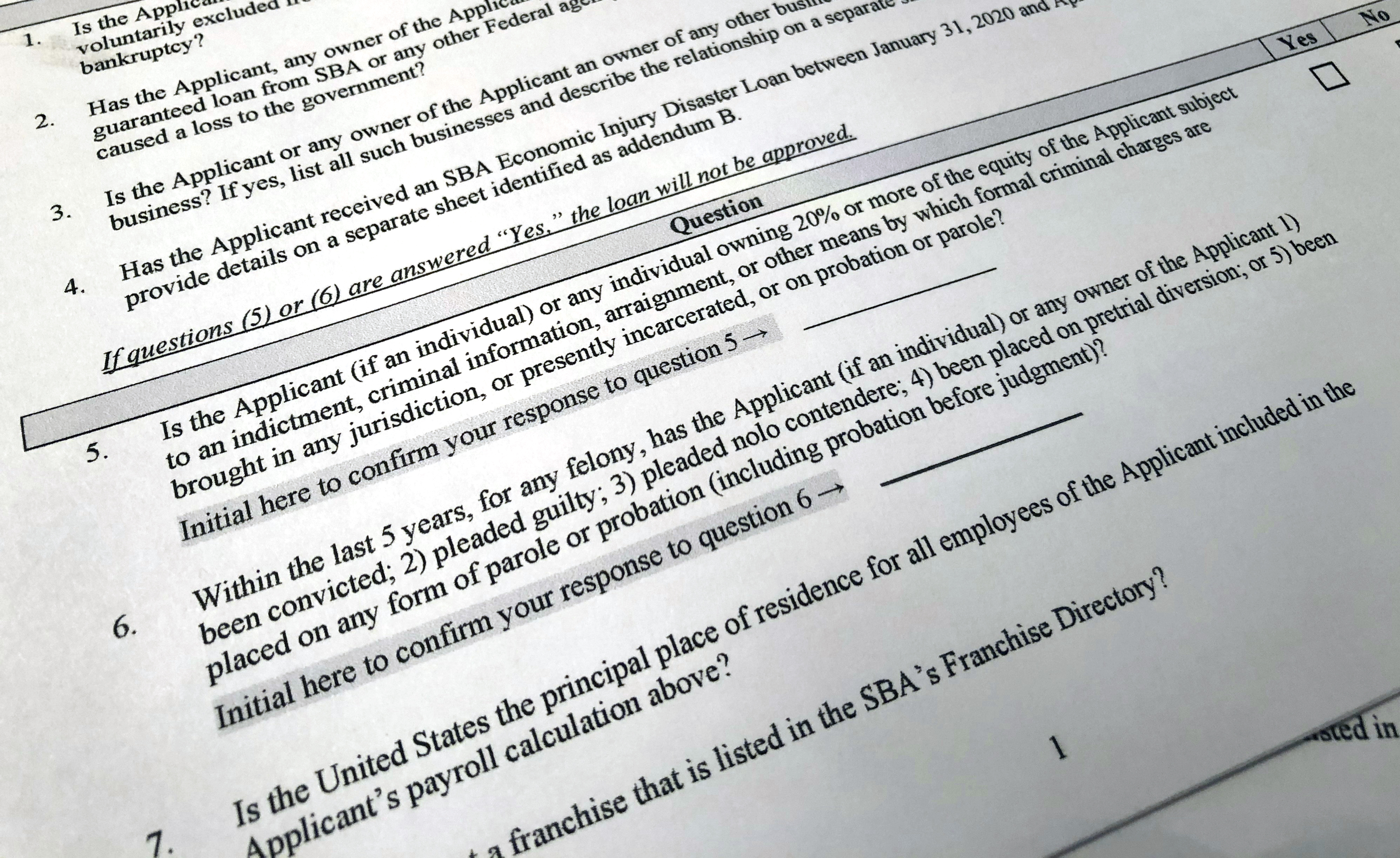 A portion of a Small Business Administration Paycheck Protection Program Borrower Application Form is seen in Washington on April 21, 2020. An Associated Press analysis published on Monday found that fraudsters potentially stole more than $280 billion in COVID-19 relief funding; another $123 billion was wasted or misspent.