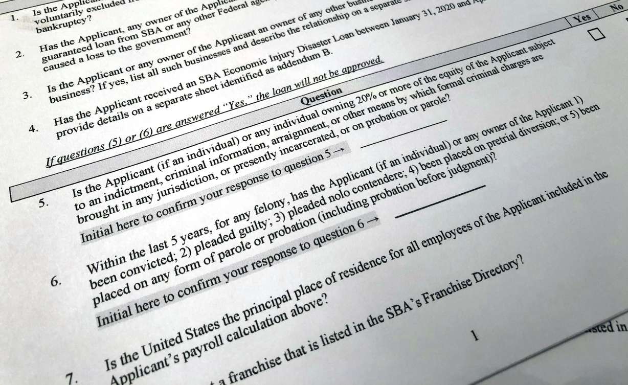 A portion of a Small Business Administration Paycheck Protection Program Borrower Application Form is seen in Washington on April 21, 2020. An Associated Press analysis published on Monday found that fraudsters potentially stole more than $280 billion in COVID-19 relief funding; another $123 billion was wasted or misspent.