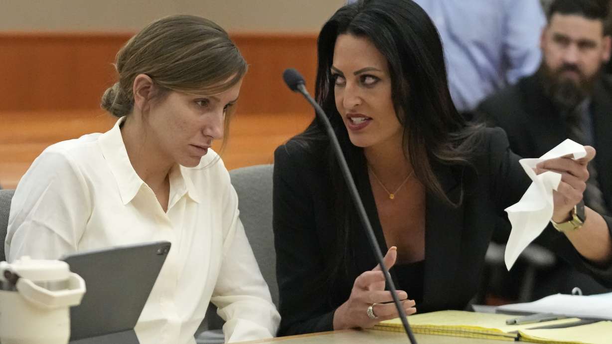 Kouri Richins, a mother of three who authorities say fatally poisoned her husband then wrote a children's book about grieving, speaks with her then-attorney Skye Lazaro during a bail hearing June 12, 2023, in Park City.