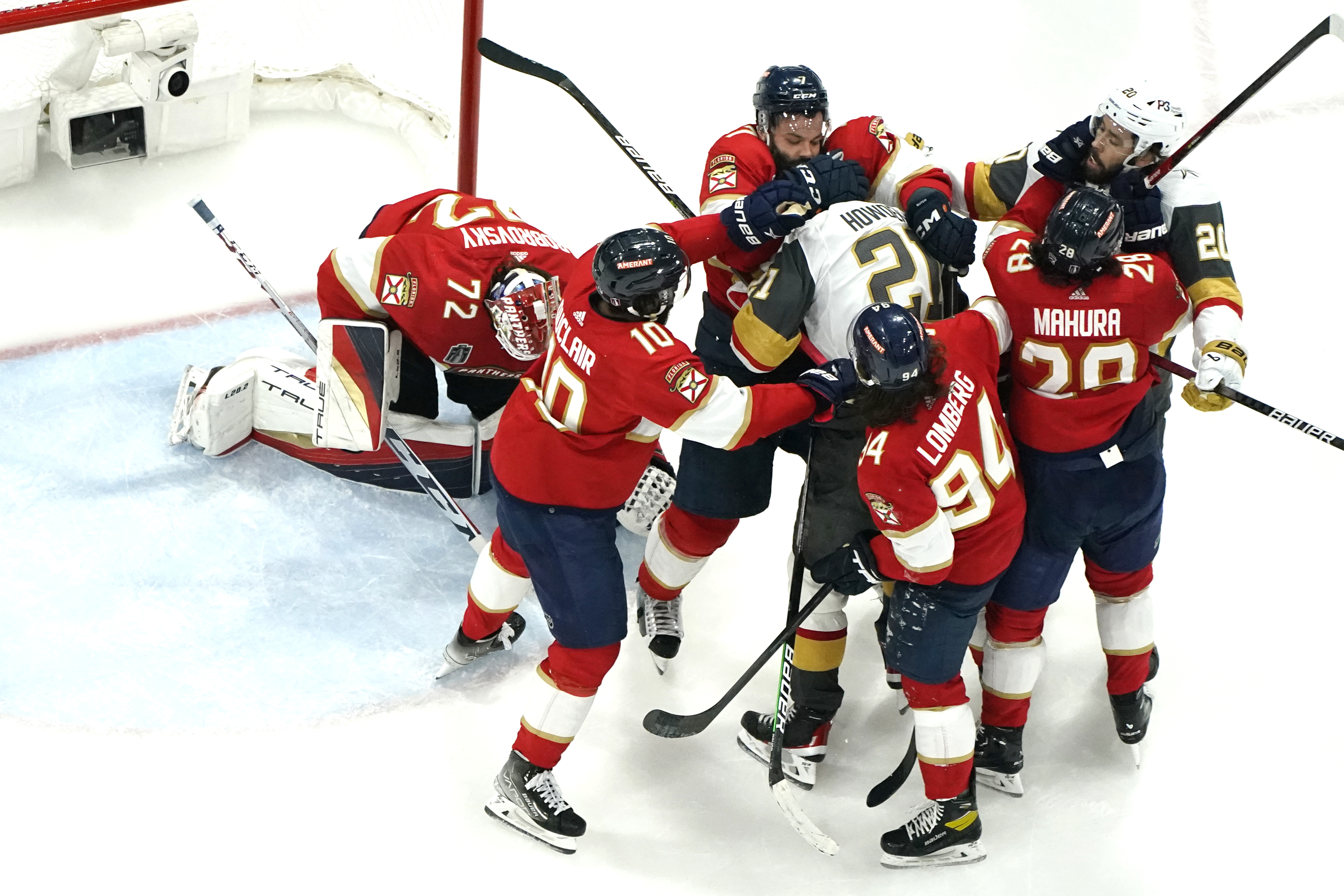 Florida Panthers defenseman Radko Gudas, center, and defenseman Josh Mahura (28) scuffle with Vegas Golden Knights Brett Howden (21) and center Chandler Stephenson (20) during the third period in Game 4 of the NHL hockey Stanley Cup Finals, Saturday, June 10, 2023, in Sunrise, Fla. 