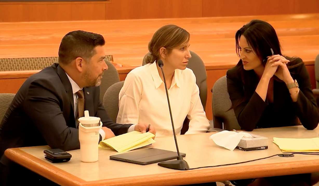 Kouri Richins, center, talks with her lawyers during a bail hearing in 3rd District court in Park City on Monday. A judge has ruled she will remain in jail, without bail, while charges accusing her of murdering her husband are pending.
