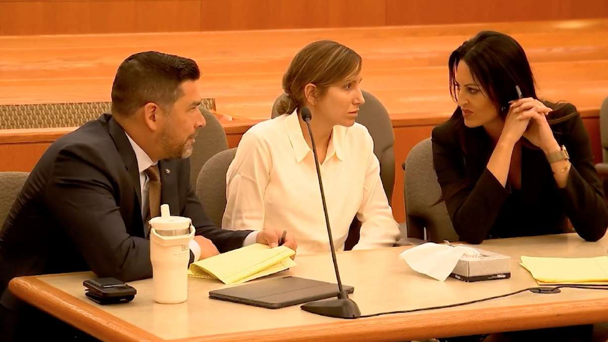 Kouri Richins, center, talks with her lawyers during a bail hearing in 3rd District Court in Park City on June 12, 2023. Eleven search warrants in Richin's case were unsealed Thursday.