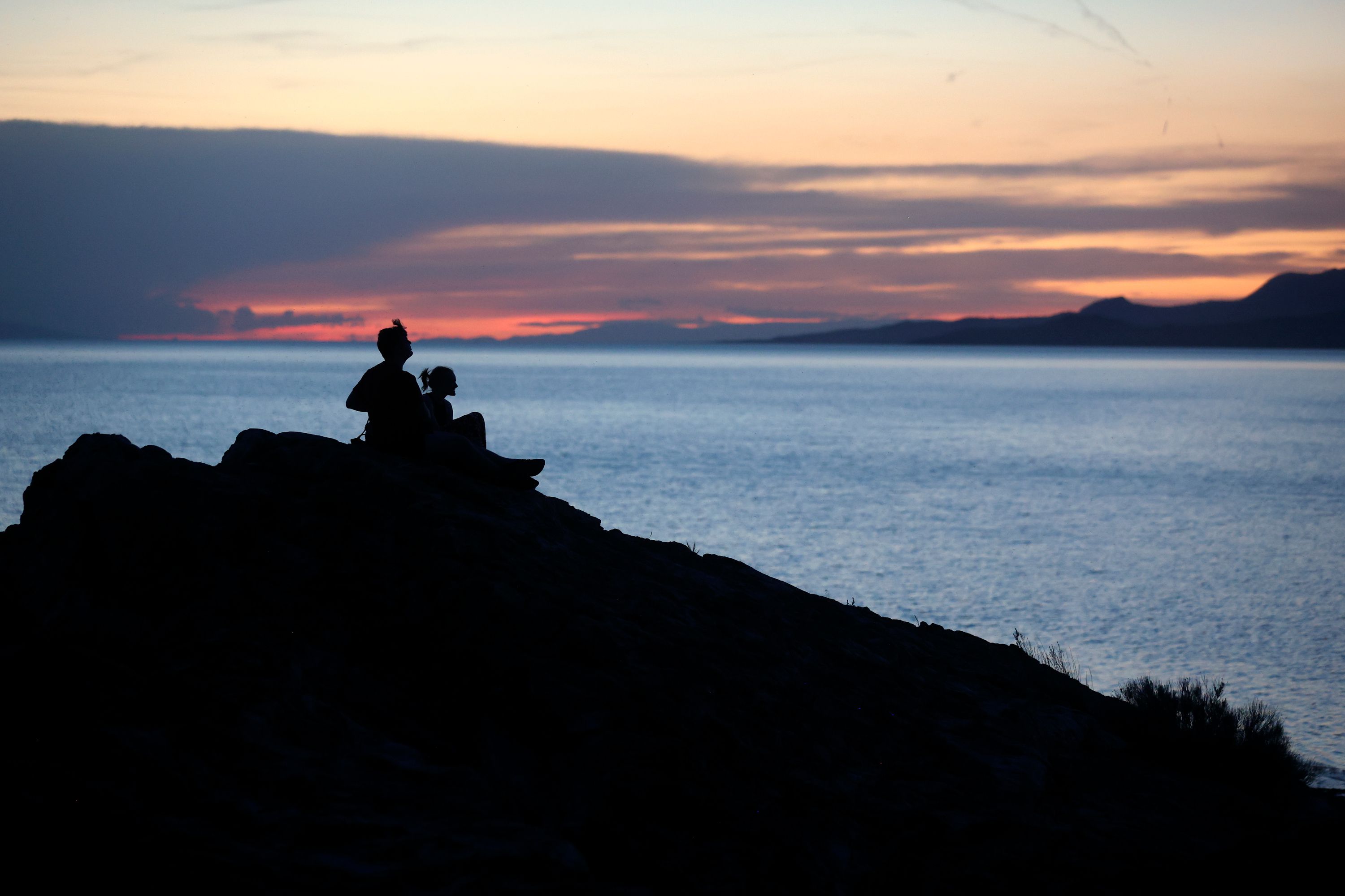 Two people watch the sunset over the Great Salt Lake from Ladyfinger Point on Antelope Island on June 5. The endless winter storms slightly dampened some of the concern Utah residents have over the Great Salt Lake.