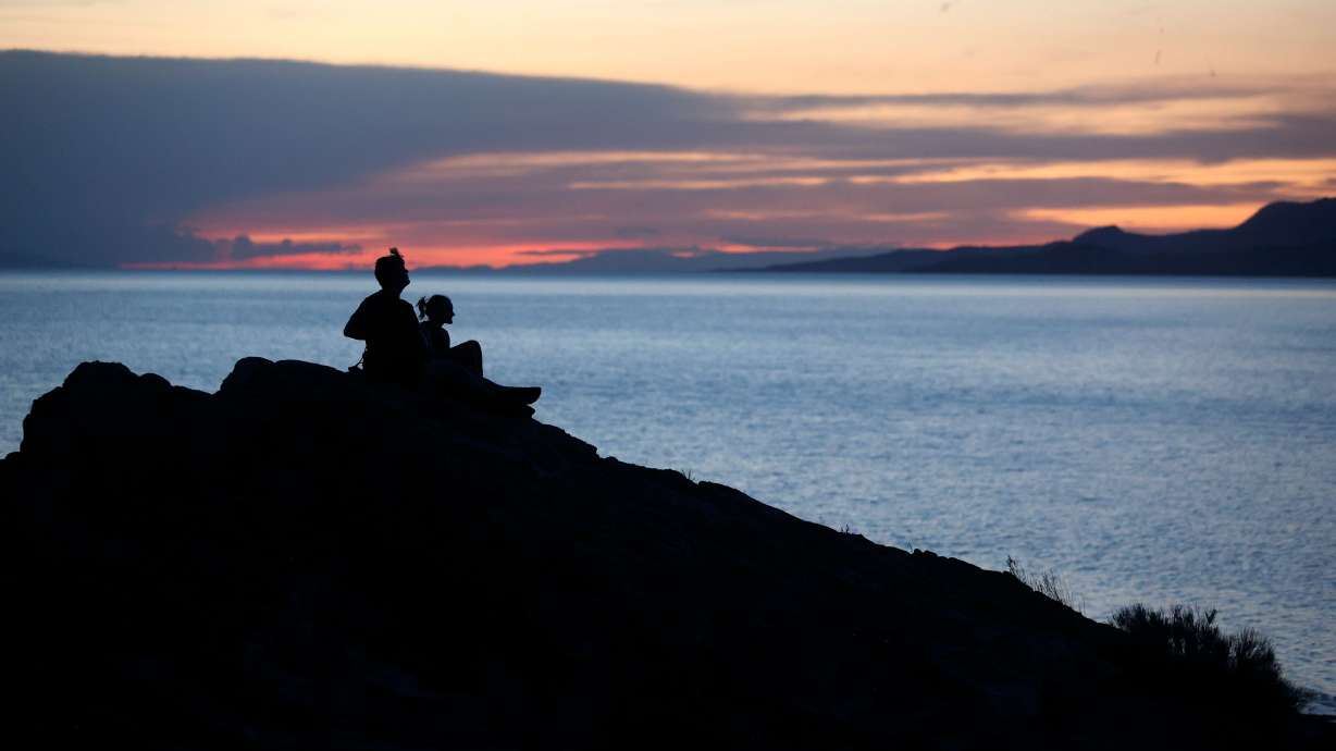 Two people watch the sunset over the Great Salt Lake from Ladyfinger Point on Antelope Island on June 5. The endless winter storms slightly dampened some of the concern Utah residents have over the Great Salt Lake.