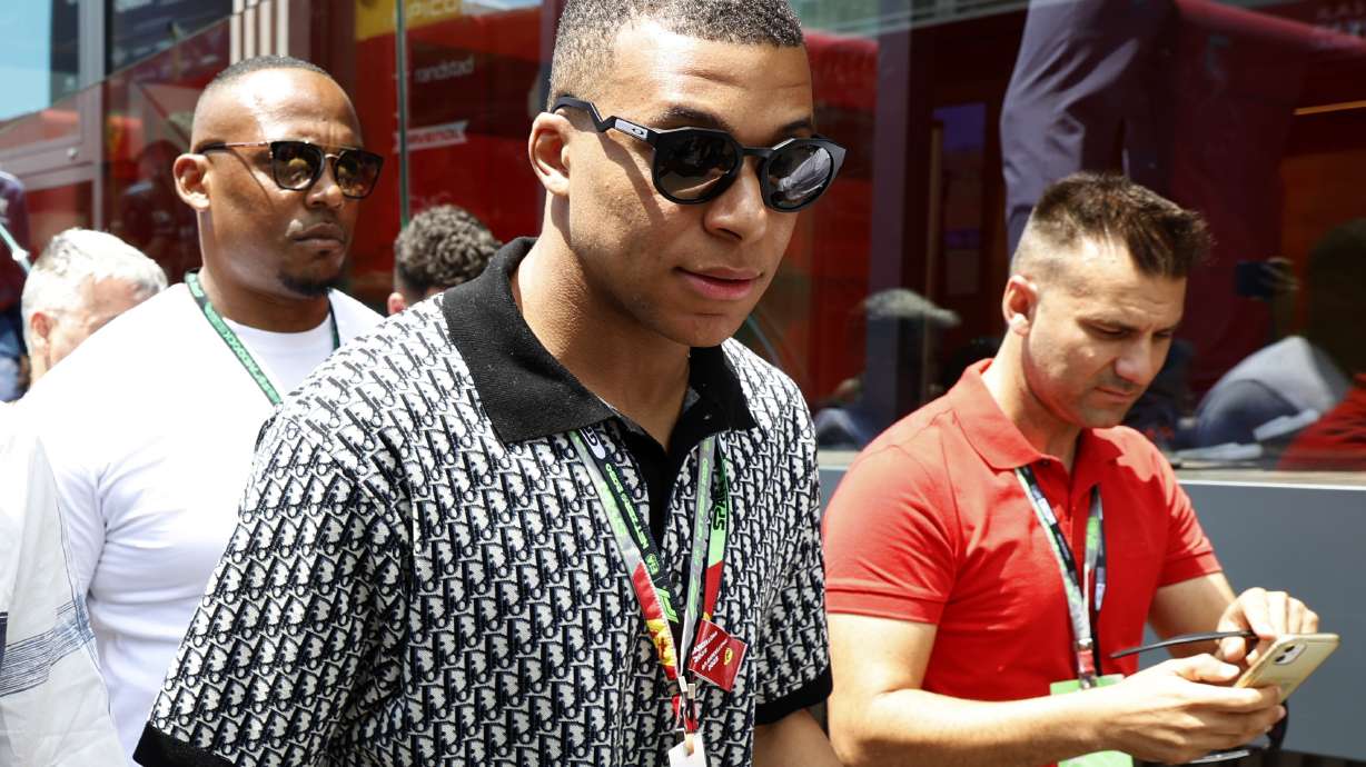French footballer Kylian Mbappe walks through the paddock before the start of the Spanish Formula One Grand Prix at the Barcelona Catalunya racetrack in Montmelo, Spain, Sunday, June 4, 2023.
