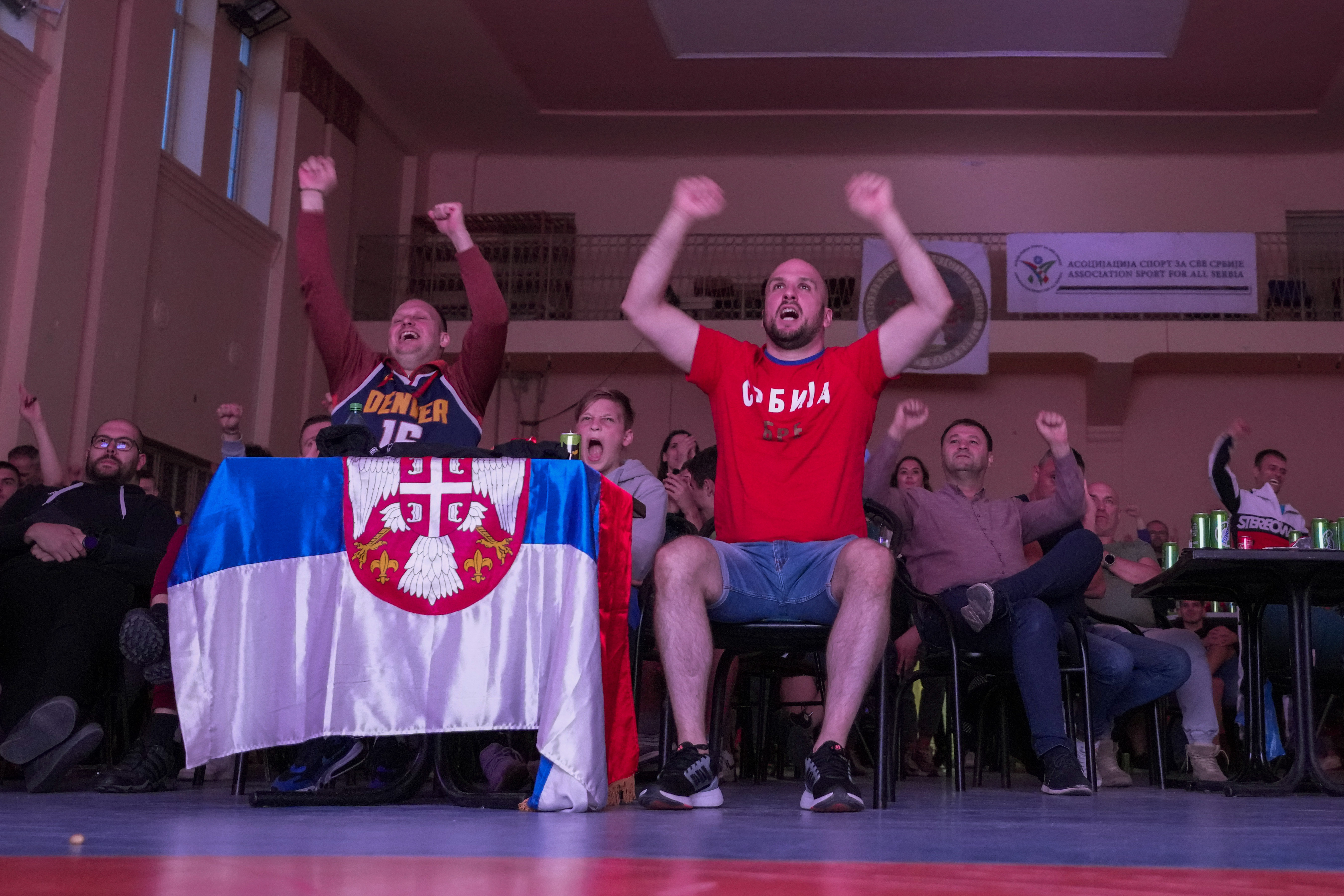 People react watch a live broadcasting of Game 5 of basketball's NBA Finals between Denver Nuggets and Miami Heat in a sports hall in the northern Serbian town of Sombor, Tuesday, June 13, 2023. It was barely dawn when Nikola Jokic’s hardcore fans in his Serbian hometown of Sombor chanted MVP, MVP and celebrated the Denver Nuggets’ first NBA title. Denver trailed Miami Heat halftime of Game 5 but rallied to win 94-89. Two-time league MVP Jokic posted 28 points and 16 rebounds and was voted Most Valuable Player of the NBA finals. 