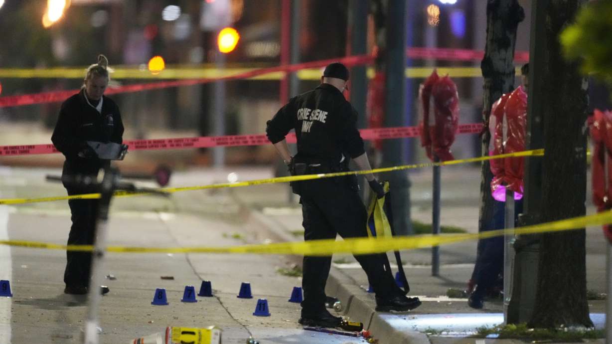 Investigators work the scene of a shooting along Market Street between 20th and 21st avenues during a celebration after the Denver Nuggets won the team's first NBA Championship early Tuesday in Denver.