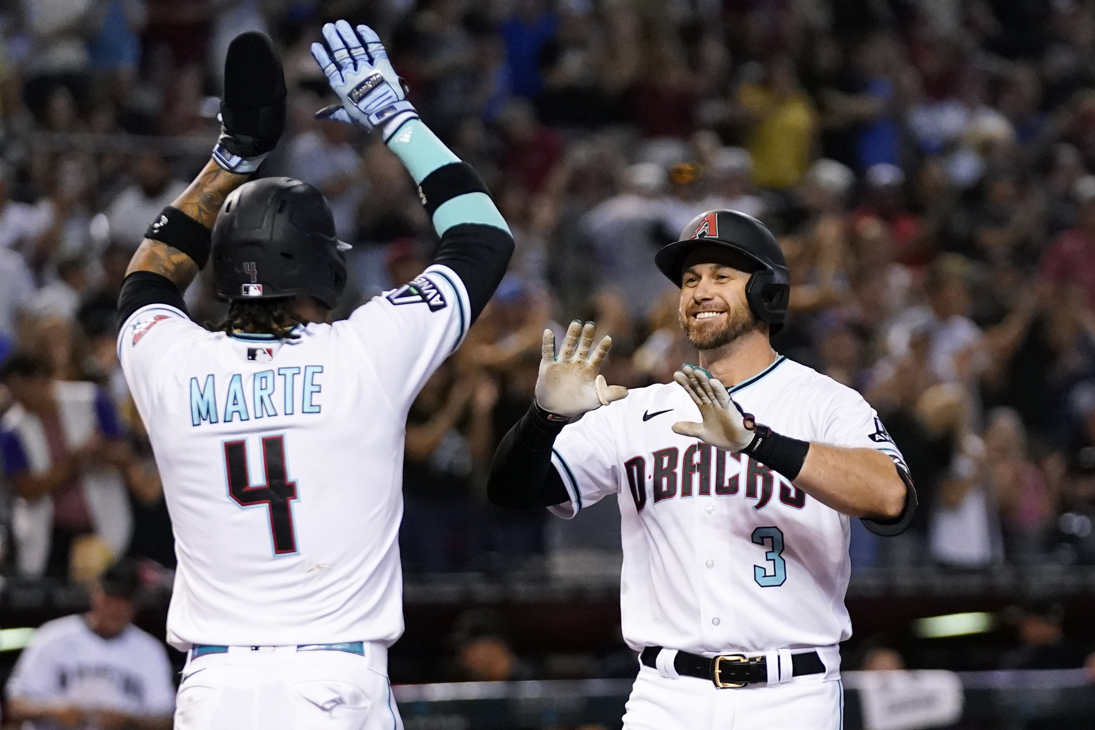 Arizona Diamondbacks' Evan Longoria (3) celebrates with teammate Ketel Marte (4) after hitting a three-run home run against the Philadelphia Phillies during the sixth inning of a baseball game Monday, June 12, 2023, in Phoenix.