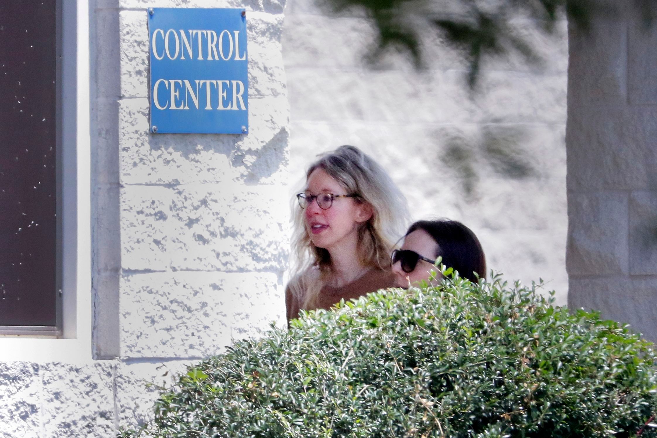 Disgraced Theranos CEO Elizabeth Holmes, left, is escorted by prison officials into a federal women's prison camp on May 30, in Bryan, Texas.