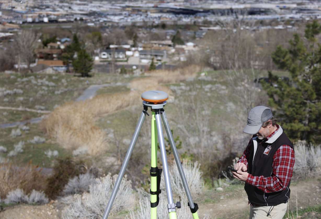Ben Erickson, senior geologist with the Utah Geological Survey, manages GPS measurement equipment located in the Springhill Drive Landslide Geologic Park in North Salt Lake on April 19. The agency reports that it is aware of more than 200 landslides across Utah this year.