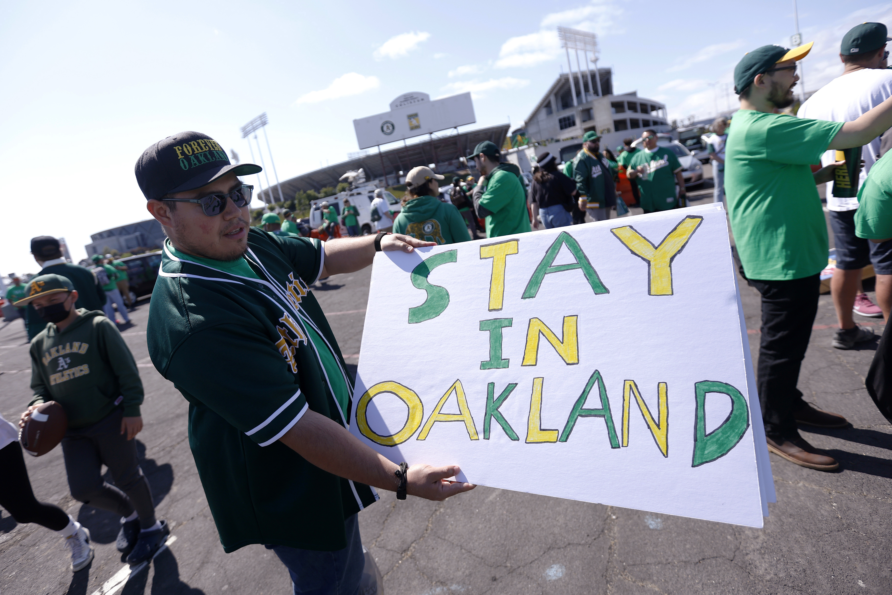 Reuben Ortiz of Modesto, Calif., holds a sign outside Oakland Coliseum to protest the Oakland Athletics' planned move to Las Vegas, before a baseball game between the Athletics and the Tampa Bay Rays in Oakland, Calif., Tuesday, June 13, 2023. 