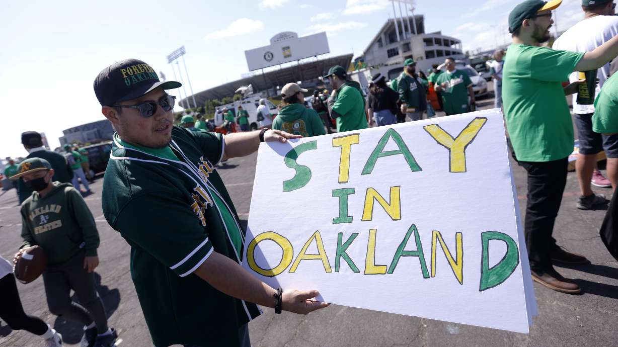 Reuben Ortiz of Modesto, Calif., holds a sign outside Oakland Coliseum to protest the Oakland Athletics' planned move to Las Vegas, before a baseball game between the Athletics and the Tampa Bay Rays in Oakland, Calif., Tuesday, June 13, 2023.