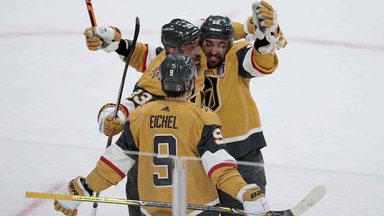 Vegas Golden Knights defenseman Alec Martinez, center, celebrates his goal with center Jack Eichel, left, and left wing William Carrier during the second period in Game 5 of the NHL hockey Stanley Cup Finals against the Florida Panthers Tuesday, June 13, 2023, in Las Vegas.