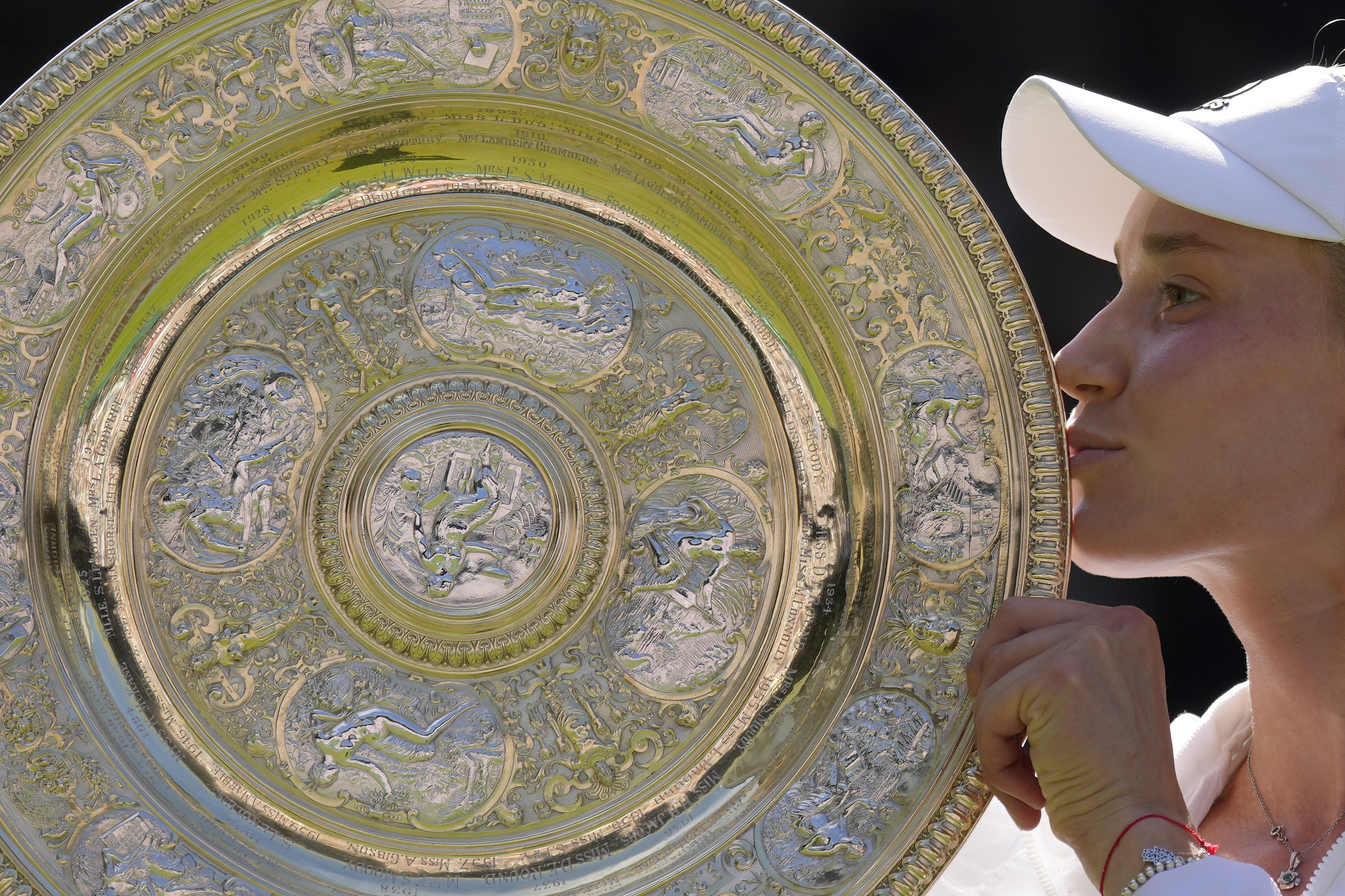 FILE - Kazakhstan's Elena Rybakina kisses the trophy as she celebrates after beating Tunisia's Ons Jabeur to win the final of the women's singles on day thirteen of the Wimbledon tennis championships in London, Saturday, July 9, 2022. Prize money at Wimbledon this year will rise by more than 11% to 44.7 million pounds ($56.5 million). It is an increase of 17.1% on the last Wimbledon before the pandemic in 2019. The winners of the singles will each receive 2.35 million pounds ($3 million). Those earnings are back to the levels they were in 2019. 