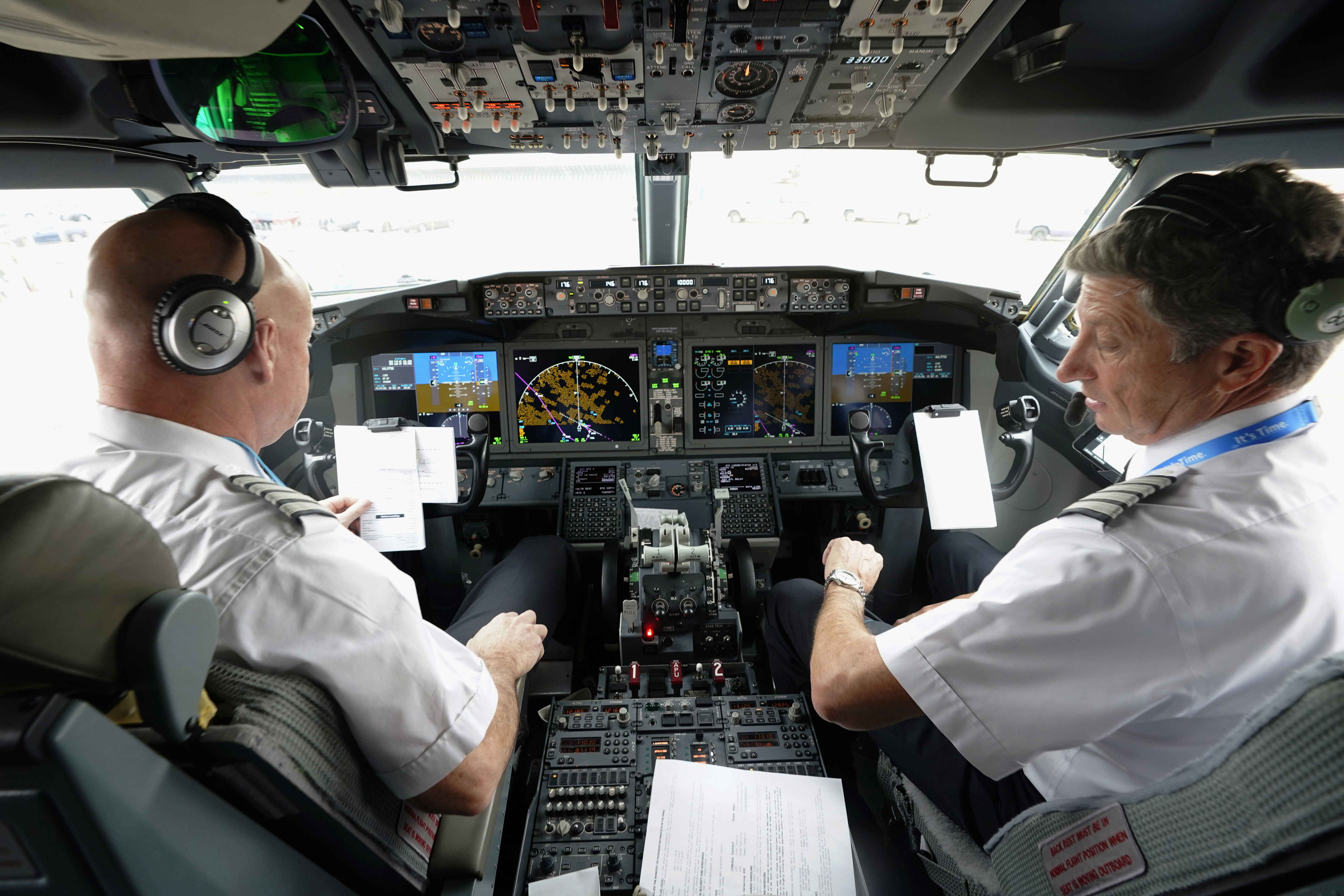 Pilots in the cockpit of a Boeing 737 Max jet, Dec. 2, 2020, in Grapevine, Texas. U.S. officials said they will require new airplanes to have a second cockpit barrier to make it harder for passengers to break in when the main door is open. 