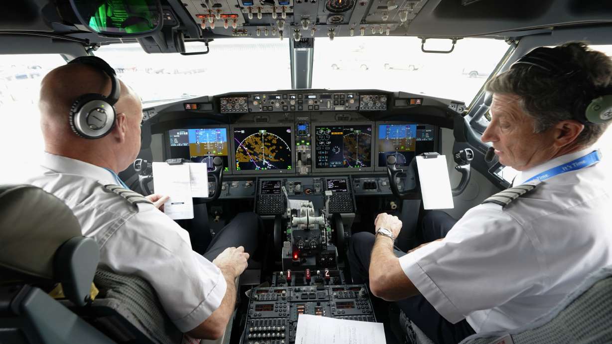 Pilots in the cockpit of a Boeing 737 Max jet, Dec. 2, 2020, in Grapevine, Texas. U.S. officials said they will require new airplanes to have a second cockpit barrier to make it harder for passengers to break in when the main door is open.