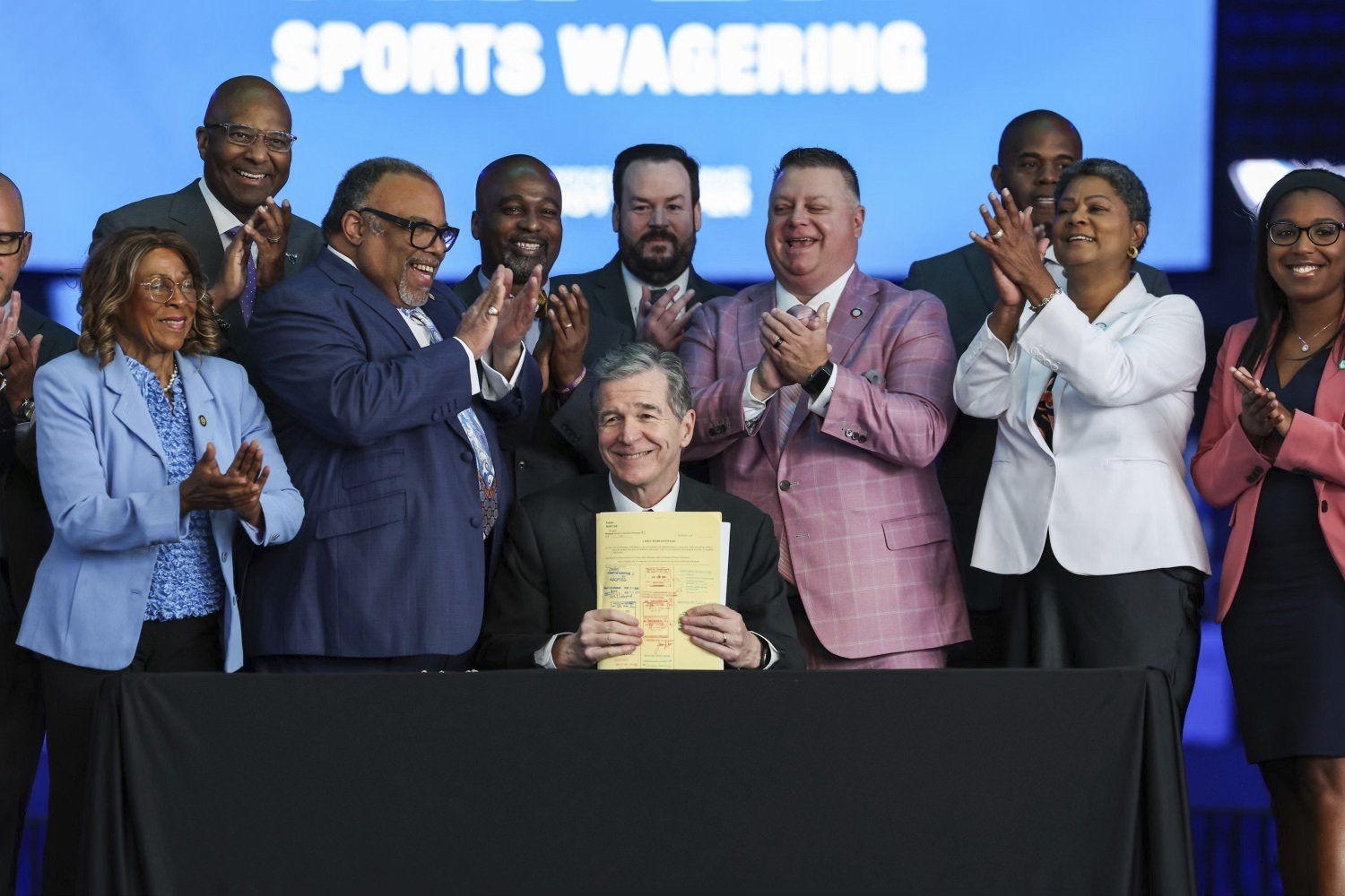 Gov. Roy Cooper signs House Bill 347: Sports Wagering/Horse Racing Wagering into law on Wednesday, June 14, 2023 at Spectrum Center in Charlotte, N.C. Regulated sports betting and horse racing should begin across North Carolina in the first half of next year after Gov. Roy Cooper signed into law Wednesday legislation that greatly expands gambling opportunities in the ninth-largest state.