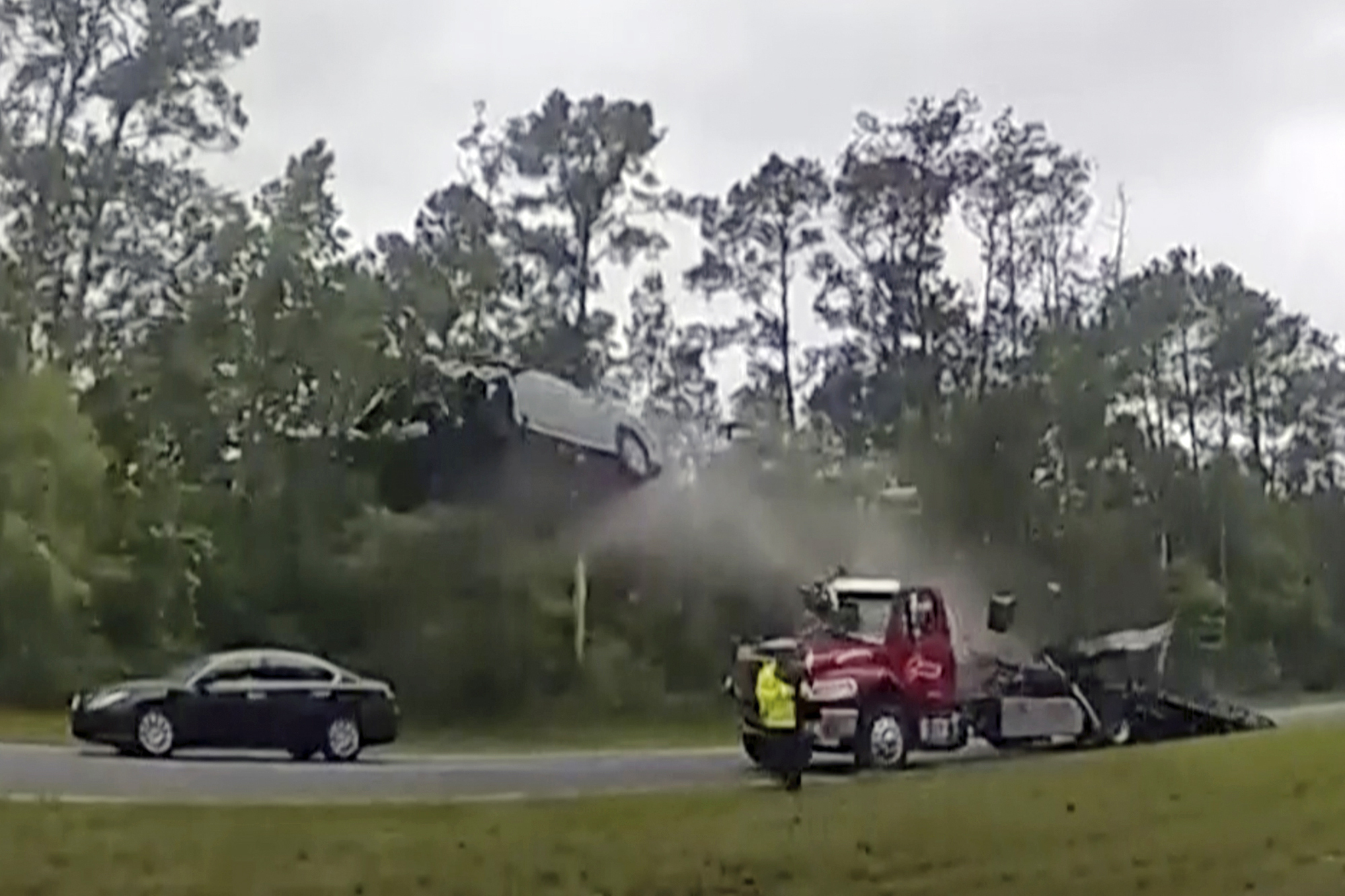 A vehicle goes airborne after driving up the ramp of a flatbed tow truck on a Georgia highway, May 24 in Lowndes County, Ga. The Nissan Altima was launched 120 feet down the highway.