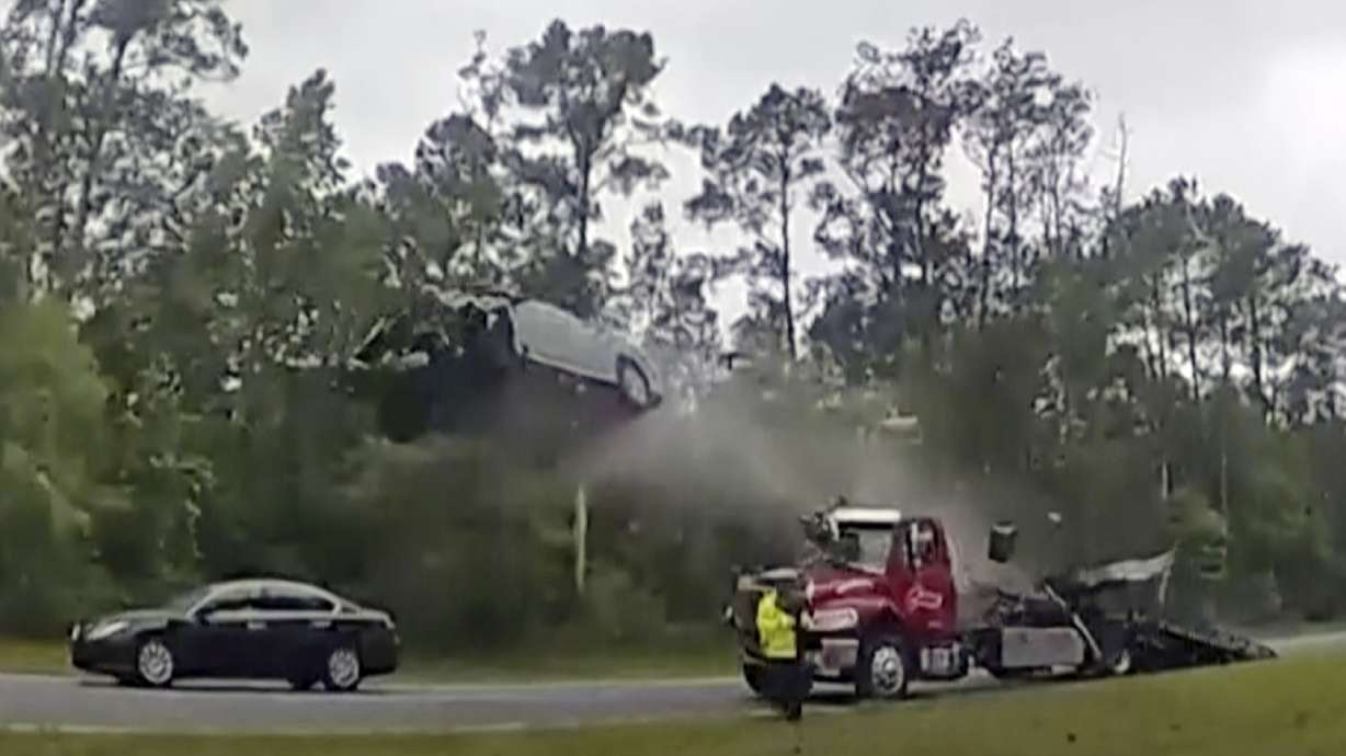 A vehicle goes airborne after driving up the ramp of a flatbed tow truck on a Georgia highway, May 24 in Lowndes County, Ga. The Nissan Altima was launched 120 feet down the highway.