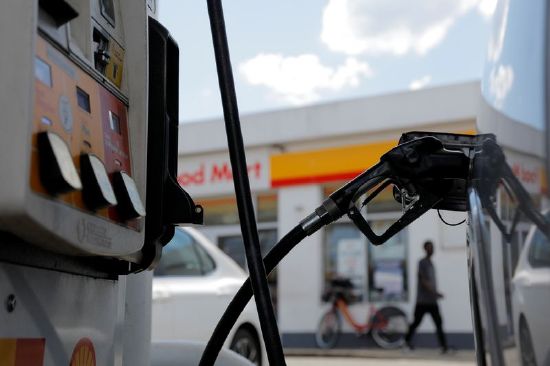 A gas pump is seen in a car at a Shell gas station, after a cyberattack crippled the biggest fuel pipeline in the country, run by Colonial Pipeline, in Washington, May 15, 2021.