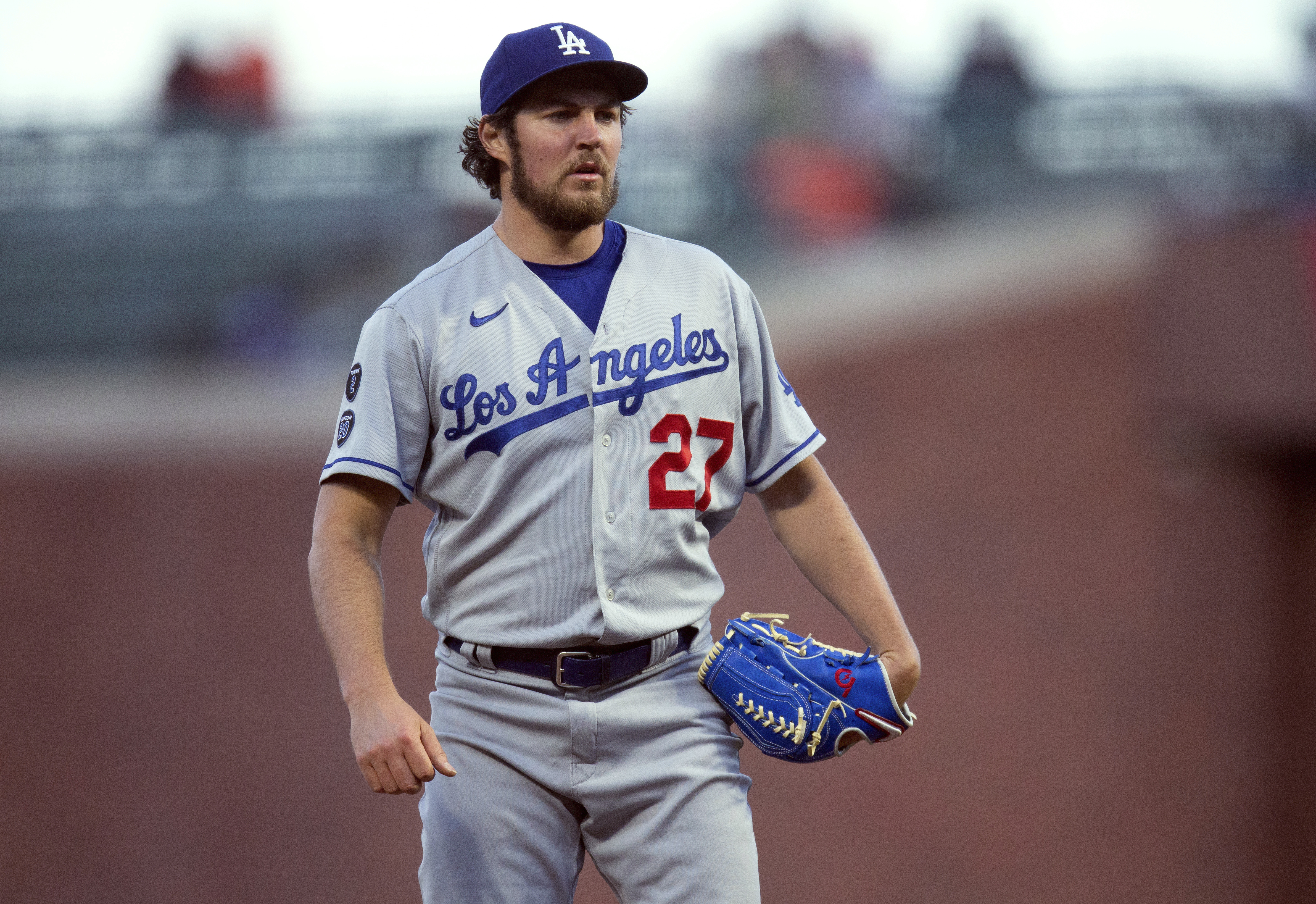 FILE - Los Angeles Dodgers starting pitcher Trevor Bauer looks toward home during the team's baseball game against the San Francisco Giants on May 21, 2021, in San Francisco. An Arizona woman has accused former pitcher Bauer of sexual assault, alleging in a lawsuit updated this week that he held a knife at her throat and choked her until she passed out during a rape that left her pregnant in late 2020. Bauer was never arrested or charged and he has countersued, denying the allegations and accusing the woman of faking a pregnancy and trying to extort money from him. 