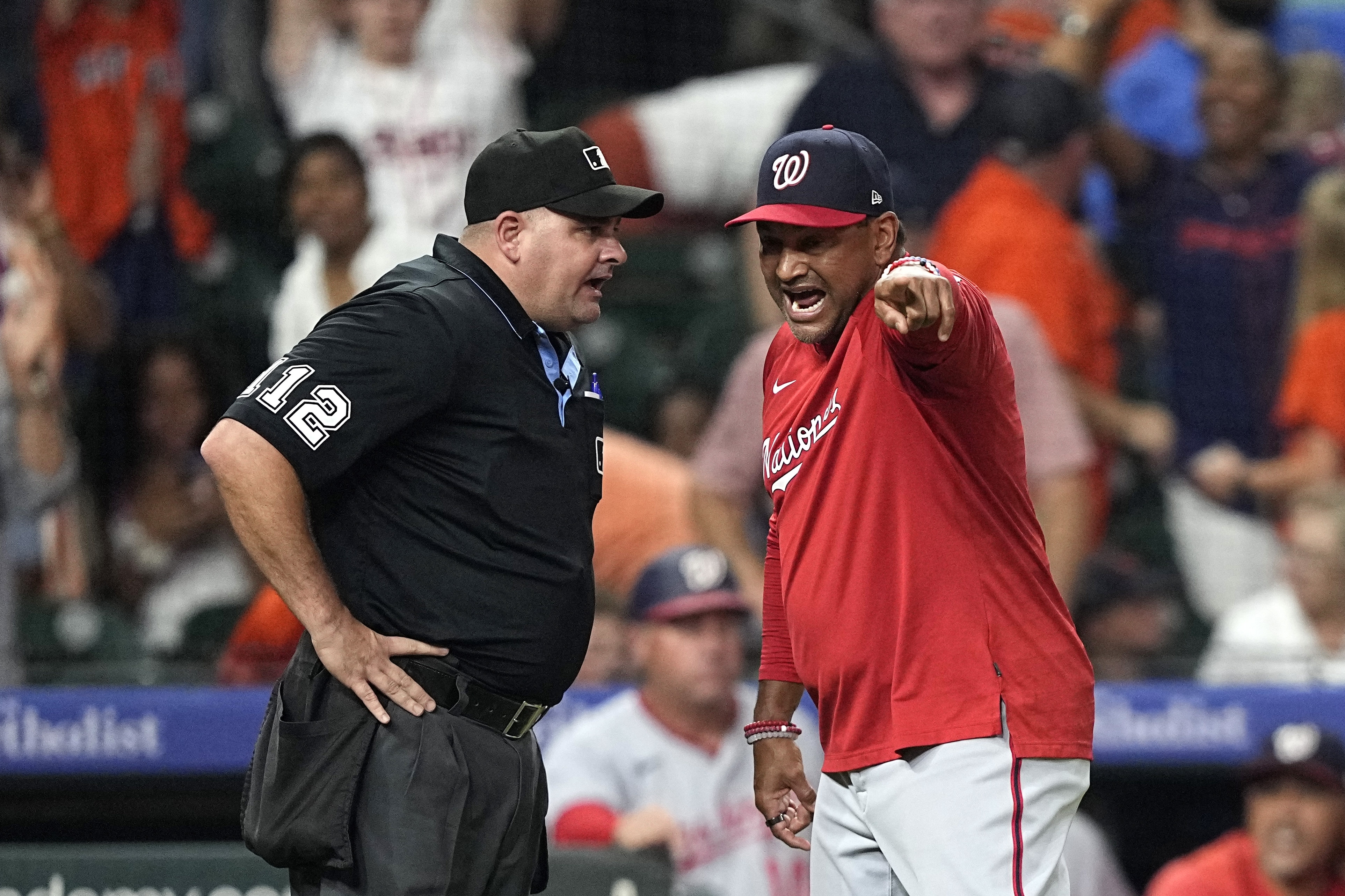 Washington Nationals manager Dave Martinez, right, argues with home plate umpire Jeremy Riggs after the final play during the ninth inning of a baseball game against the Houston Astros Wednesday, June 14, 2023, in Houston. The Astros won 5-4.