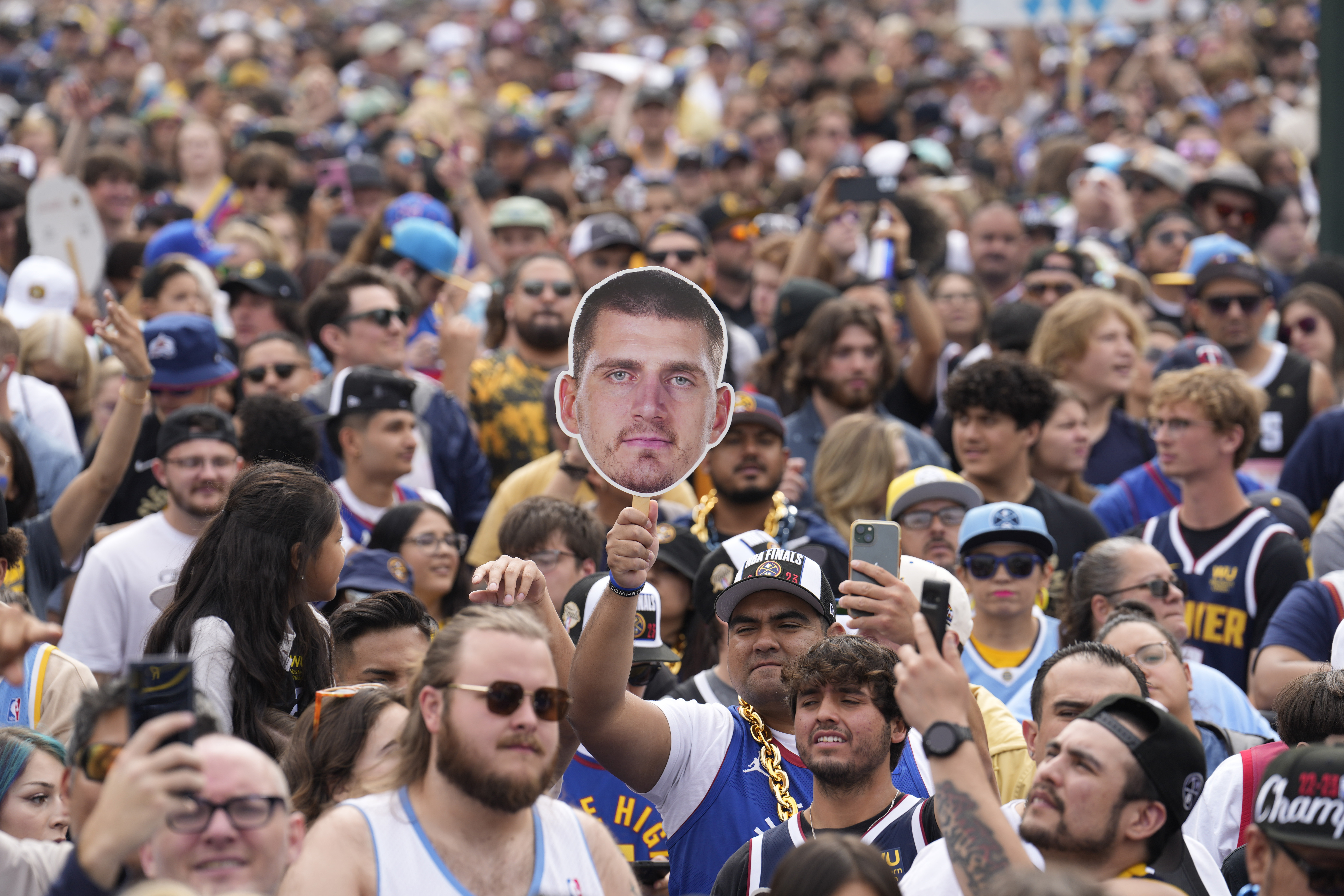A fan holds up a cutout of Denver Nuggets center Nikola Jokic during a rally and parade to mark the Denver Nuggets first NBA basketball championship on Thursday, June 15, 2023, in Denver. 