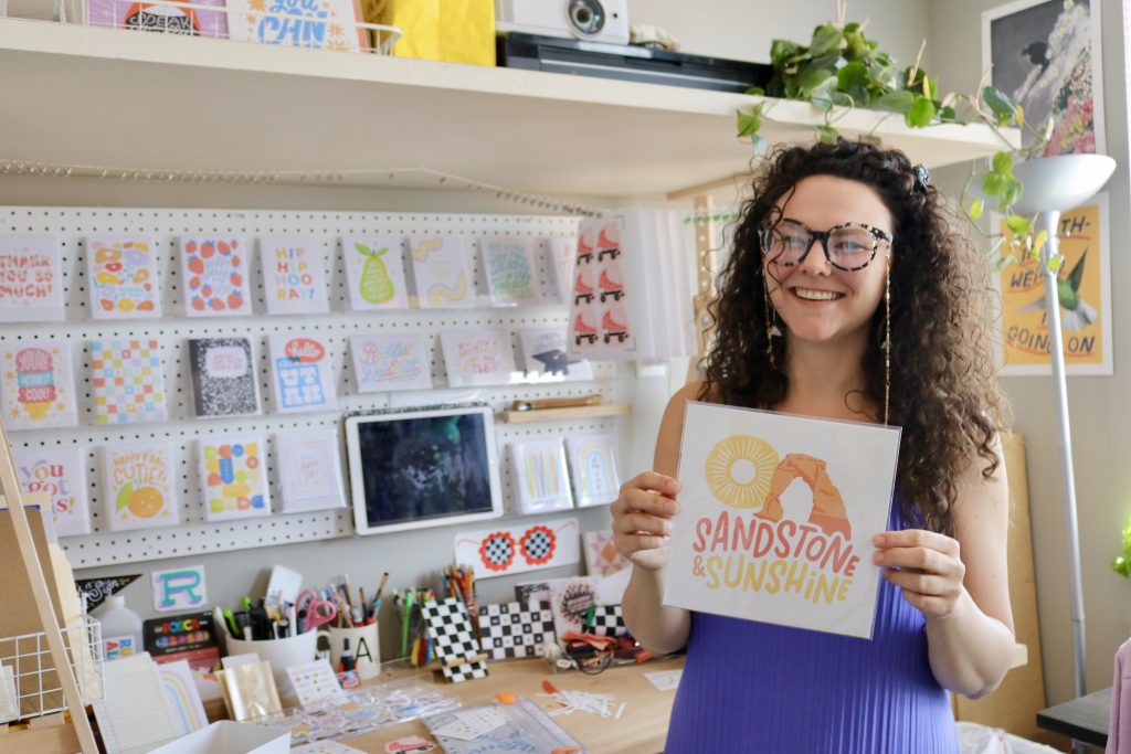 Alex Peterson shows one of her hand-drawn designs inspired by the Southern Utah landscape, Ivins, June 8.