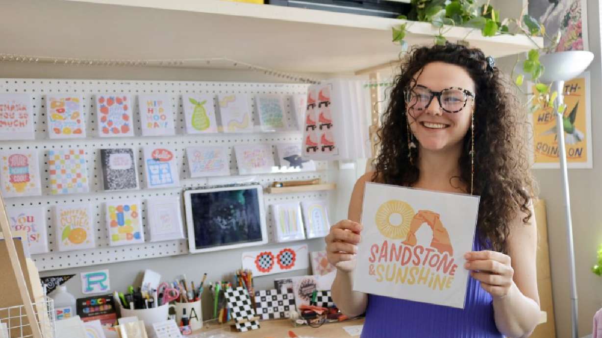 Alex Peterson shows one of her hand-drawn designs inspired by the Southern Utah landscape, Ivins, June 8.