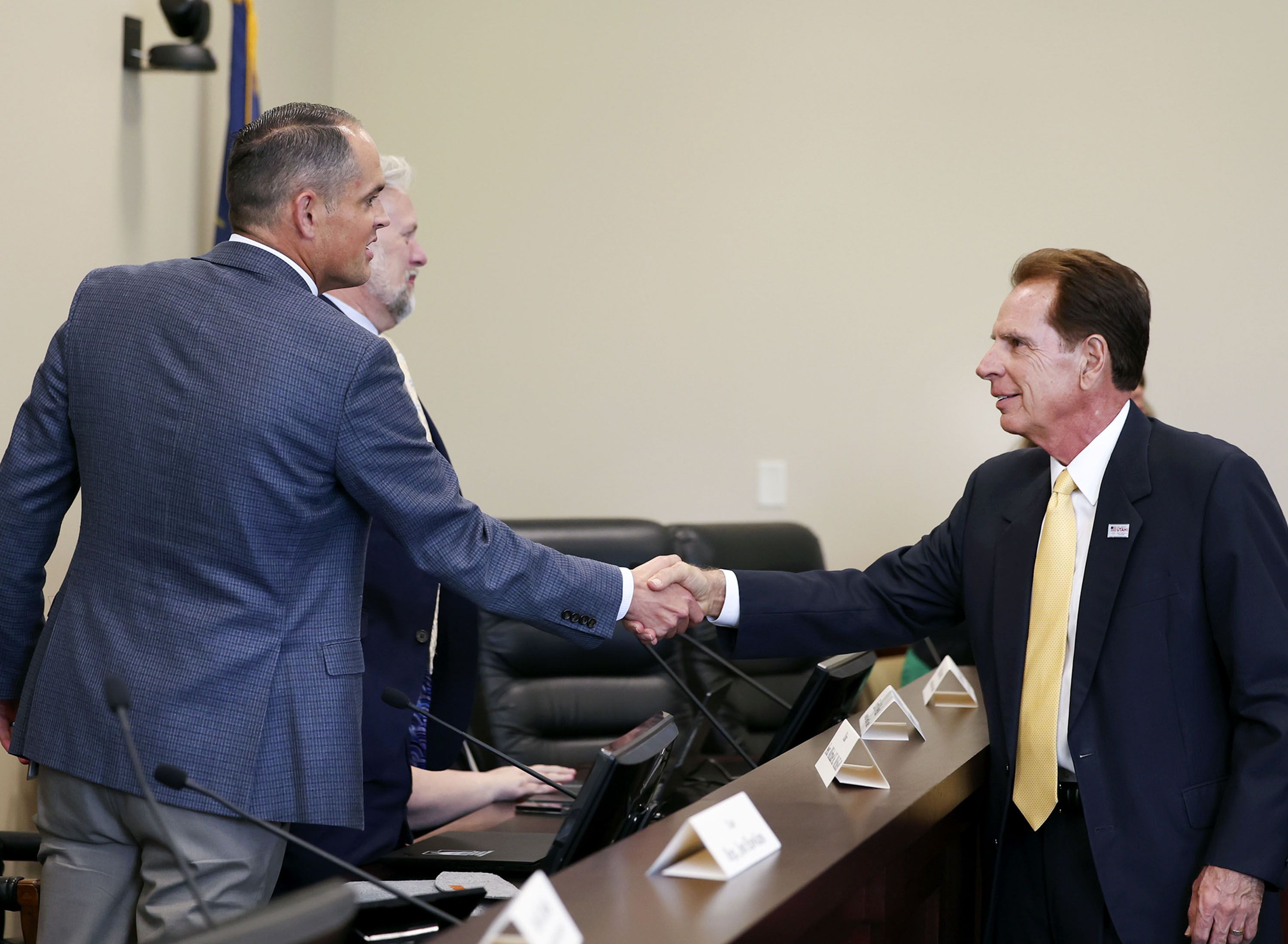 State Sen. Mike McKell, R-Spanish Fork, left, shakes hands with Fraser Bullock, president and CEO of the Salt Lake City-Utah Committee for the Games, after the Legislature’s Olympic committee met at the Capitol in Salt Lake City on Thursday.