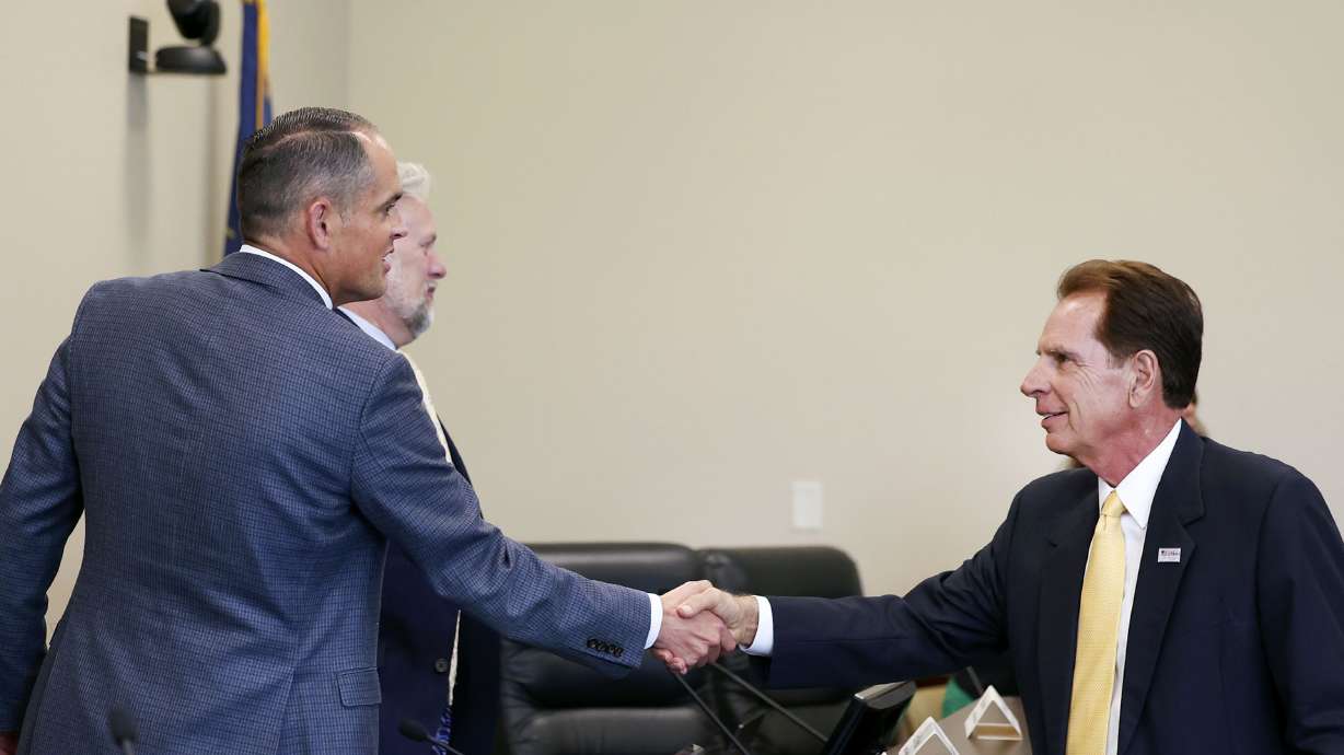 State Sen. Mike McKell, R-Spanish Fork, left, shakes hands with Fraser Bullock, president and CEO of the Salt Lake City-Utah Committee for the Games, after the Legislature’s Olympic committee met at the Capitol in Salt Lake City on Thursday.